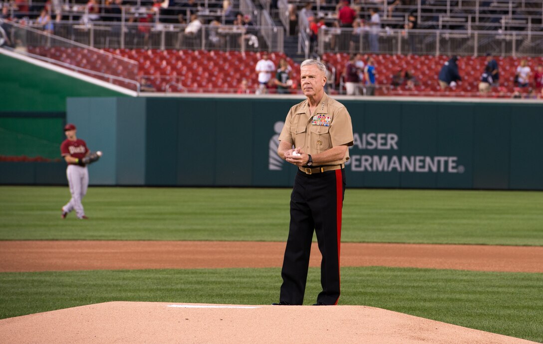 General James Amos, the commandant of the Marine Corps, prepares to throw the opening pitch of the Washington Nationals Marine Corps Day game against the Arizona Diamondbacks at Nationals Park in Washington, D.C., August 20, 2014. Marines lined the foul lines to watch their commandant and to salute the flag during the national anthem played by the Marine Corps Base Quantico Band.