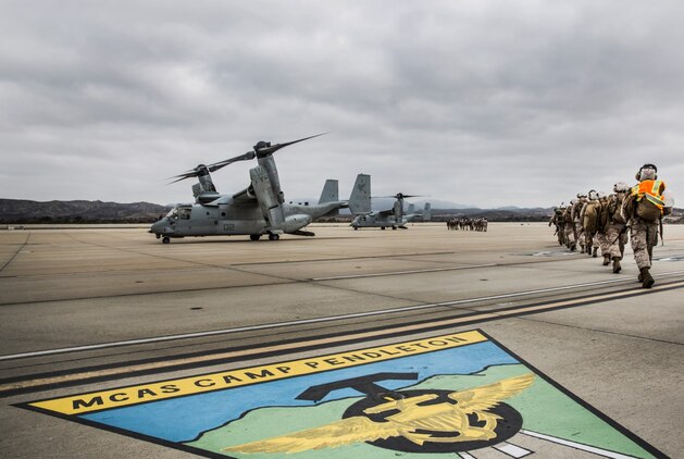 Marines assigned to Combat Logistics Battalion 15 make their way to MV-22 Ospreys during a movement to Marine Corps Mountain Warfare Training Center from Marine Corps Air Station Camp Pendleton, Calif., on Aug. 19, 2014. These Marines will participate in Mountain Exercise at MCMWTC aboard Bridgeport, Calif. (U.S. Marine Corps photo by Sgt. Emmanuel Ramos/Released)