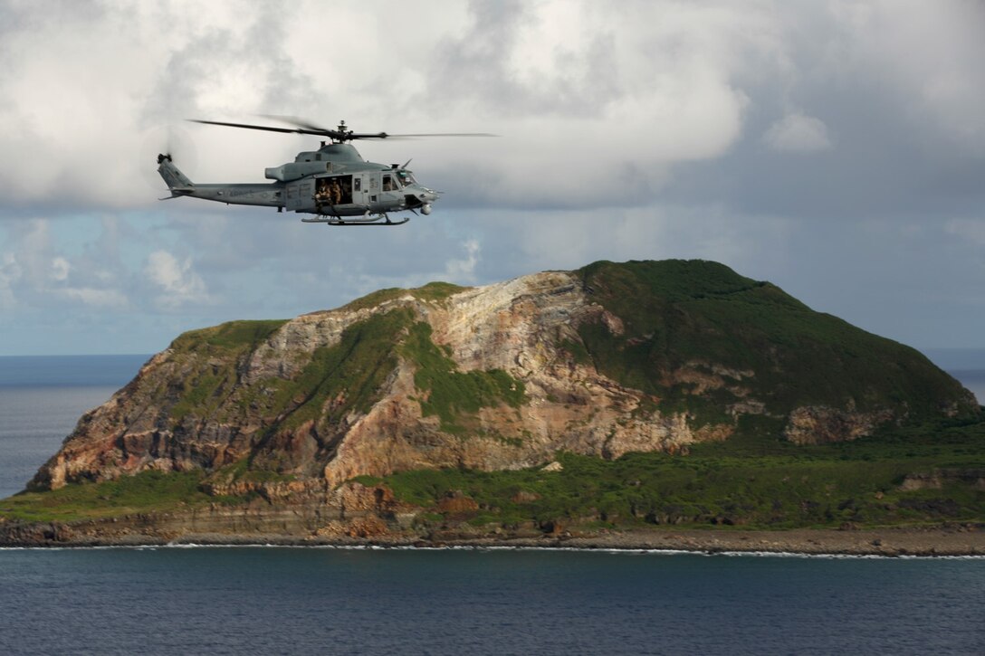 A UH-1Y Super Huey from Marine Medium Tiltrotor Squadron 163 (Reinforced), 11th Marine Expeditionary Unit, flies near Mt. Suribachi on the island of Iwo To, Japan during the 11th MEU's WestPac 14-2 deployment, Aug. 16, 2014. The 11th MEU and Makin Island Amphibious Ready Group are deployed to the U.S. 7th Fleet area of operations as a sea-based, expeditionary crisis response force capable of conducting amphibious missions across the full range of military operations. (U.S. Marine Corps photo by Cpl. Jonathan R. Waldman/RELEASED)