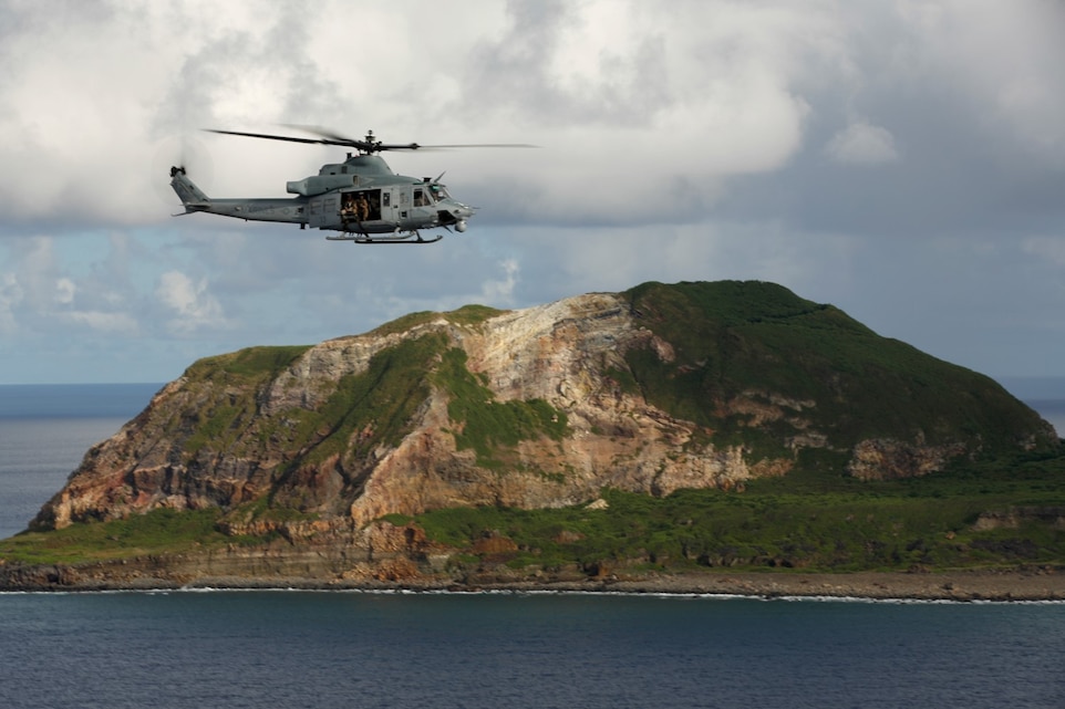 A UH-1Y Super Huey from Marine Medium Tiltrotor Squadron 163 (Reinforced), 11th Marine Expeditionary Unit, flies near Mt. Suribachi on the island of Iwo To, Japan during the 11th MEU's WestPac 14-2 deployment, Aug. 16, 2014. The 11th MEU and Makin Island Amphibious Ready Group are deployed to the U.S. 7th Fleet area of operations as a sea-based, expeditionary crisis response force capable of conducting amphibious missions across the full range of military operations. (U.S. Marine Corps photo by Cpl. Jonathan R. Waldman/RELEASED)