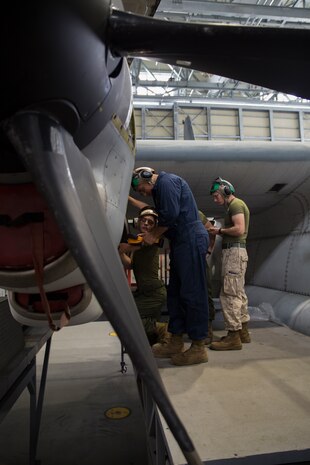 Powerline mechanic Marines with Marine Aerial Refueler Squadron 152 perform maintenance on a KC-130J Super Hercules aboard Marine Corps Air Station Iwakuni, Japan, Aug. 19, 2014. Upon VMGR-152’s relocation to MCAS Iwakuni from their former home of Okinawa, Japan, in July, the squadron now utilizes new facilities and gear, making mission accomplishment easier.