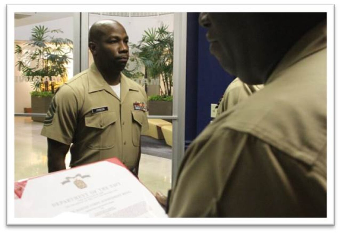 GySgt. Stacey Johnson, the former Officer Selection Assistant from Recruiting Station Baton Rouge, stands at attention during the presentation of his 5th Navy Achievement Medal at Recruting Station Baton Rouge, July 28, 2014. GySgt. Stacey Johnson was presented a Navy Achievement Medal for his selfless devotion to duty while serving as the Recruiting Station’s Officer Selection Assistant. (Official Marine Corps photo by Sgt. Rubin J. Tan)
   
