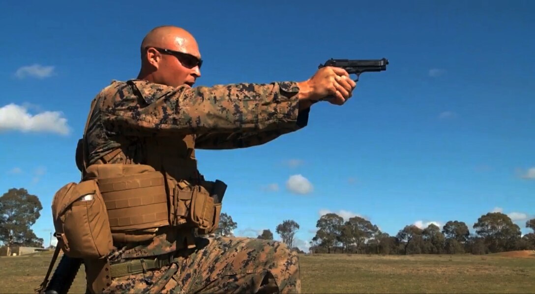 First Lieutenant Andrew H. Walker engages targets at unknown distances with the Beretta M9 pistol during the Australian Army Skill at Arms Meeting May 3, 2014. The AASAM is an annual weapons based competition where Armed Forces from around the globe compete against one another. Walker is the assistant logistics officer for Battalion Landing Team 3rd Battalion, 5th Marines, 31st Marine Expeditionary Unit, and a native of Raleigh, North Carolina. Walker was selected to join the Marine Corps shooting team for the AASAM as a result of his high placement during the 2014 Marine Corps Competition-in-Arms Program Western Division Matches and several years of civilian competitive shooting. 