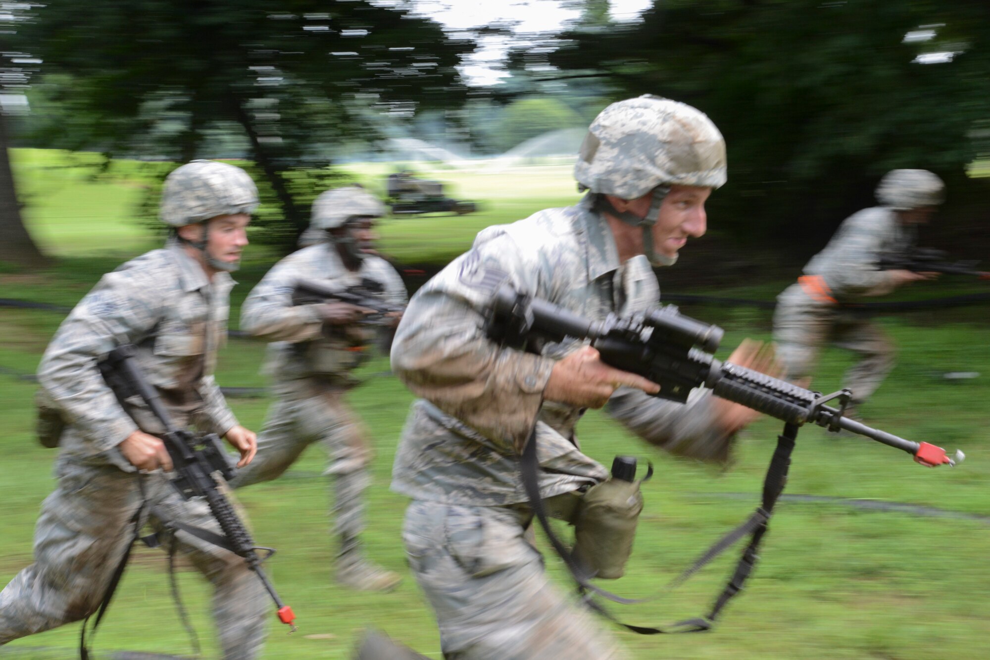 Airmen from the 374th Civil Engineer Squadron sprint before hitting the dirt during the short rush technique portion of the 374 CES Prime Beef training day at Yokota Air Base, Japan on Aug. 21, 2014. The short rush is a movement tactic where the individual moves from cover to cover in short, three to five second bursts. (U.S. Air Force photo by Senior Airman Michael Washburn/released)