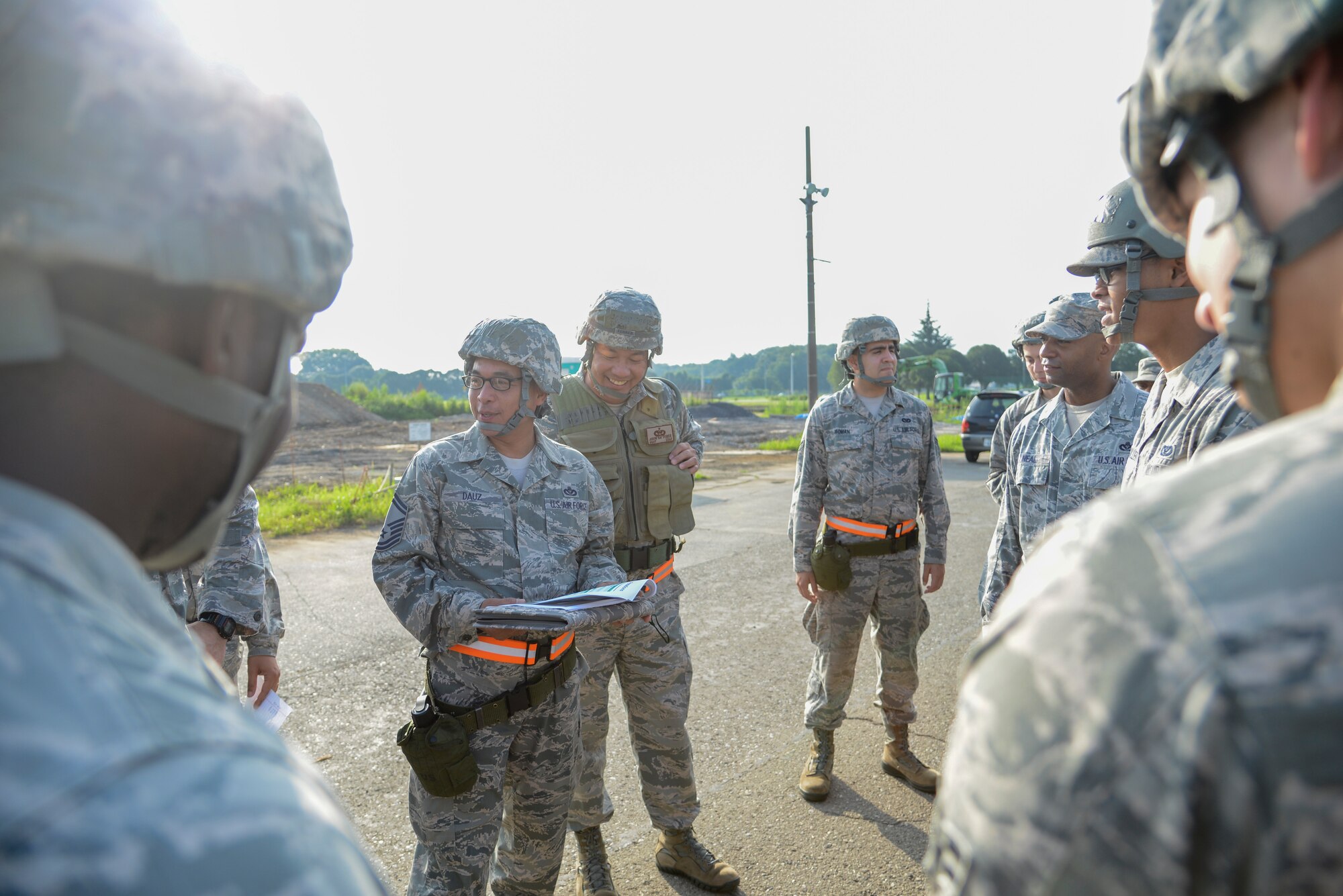 Senior Master Sgt. Roel Dauz, 374th Civil Engineer Squadron facility systems superintendent, briefs a group of Airmen on an exercise during the 374 CES Prime Beef training day at Yokota Air Base, Japan on Aug. 21, 2014. The day’s exercises consisted of cover and concealment, stealth, movement tactics and movement techniques. (U.S. Air Force photo by Senior Airman Michael Washburn/released)