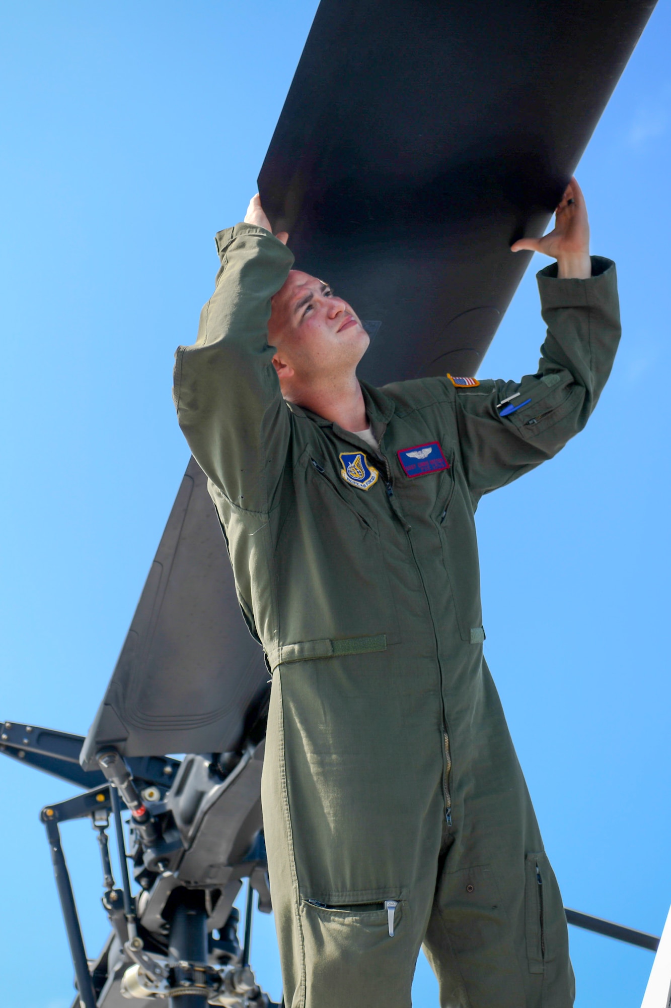 Staff Sgt. Christopher Rector, 459th Airlift Squadron flight engineer, performs an inspection at Sendai Airport, Miyagi prefecture, Japan on Aug. 20, 2014, during a training mission. Airmen from the 459 AS regularly practice their airlift capabilities in order to respond to regional contingencies. (U.S. Air Force photo by Airman 1st Class Meagan Schutter/Released)