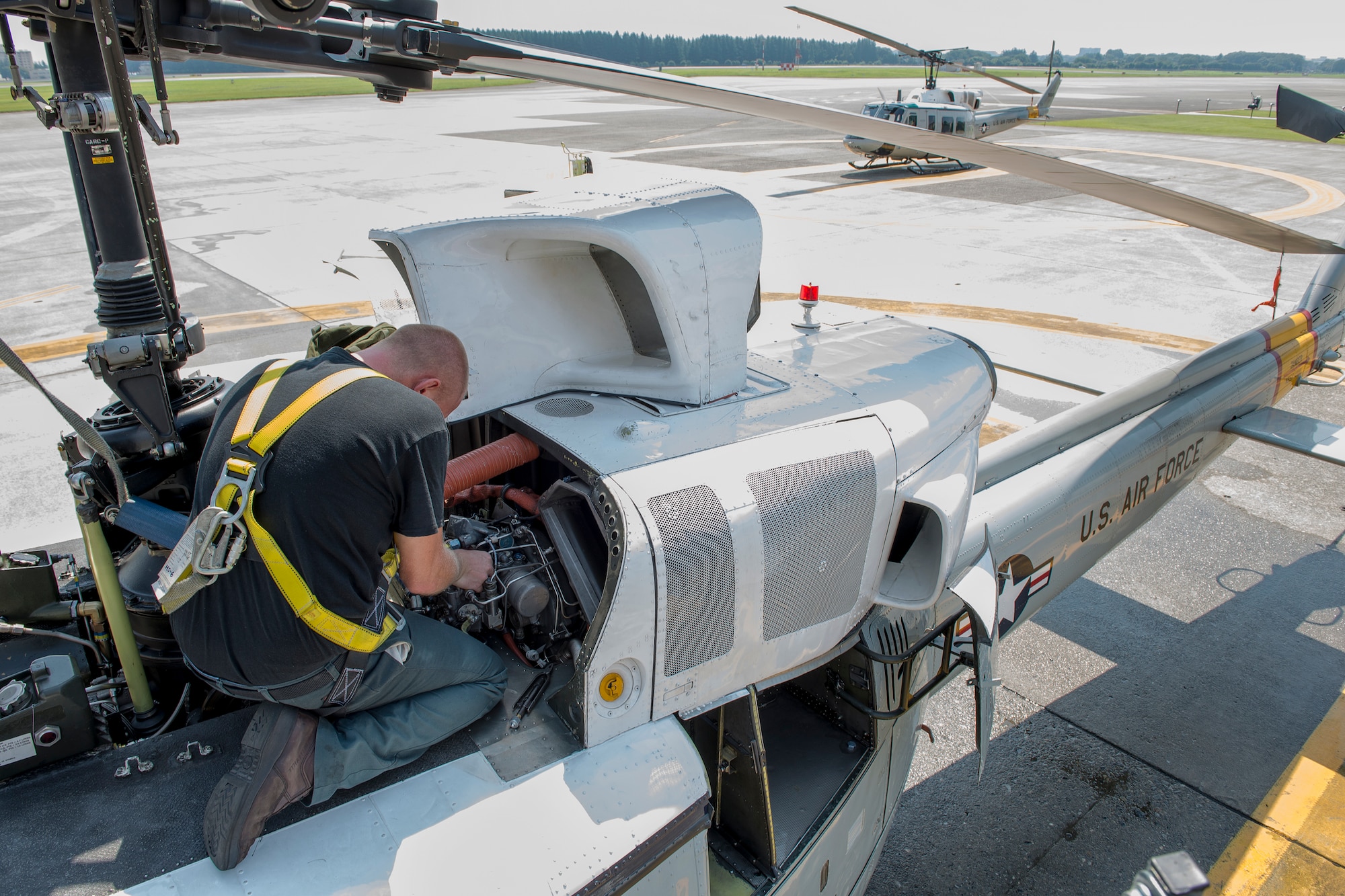 Joshua Keller, 374th Maintenance Group contractor, maintains a UH-1N Iroquois at Yokota Air Base, Japan on Aug. 20, 2014. The UH-1N maintainers from the 374th MXG ensure the helicopters are prepared to respond to any type of mission—day or night. (U.S. Air Force photo by Osakabe Yasuo/Released)