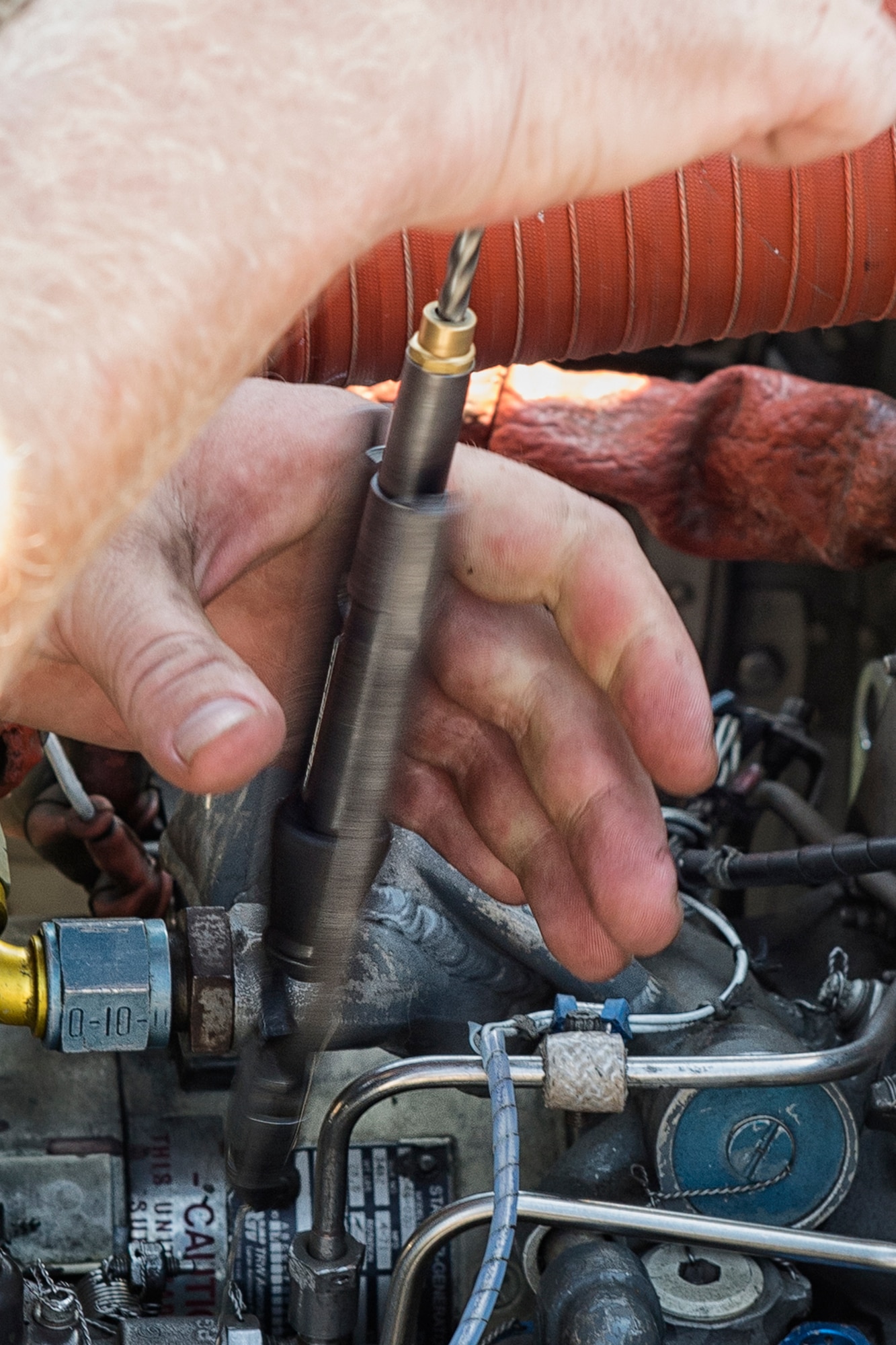 Joshua Keller, 374th Maintenance Group contractor, uses safety wire pliers to tighten a part on a UH-1N Iroquois at Yokota Air Base, Japan on Aug. 20, 2014. The safety wire technique is one of many skills employed by helicopter maintainers. (U.S. Air Force photo by Osakabe Yasuo)