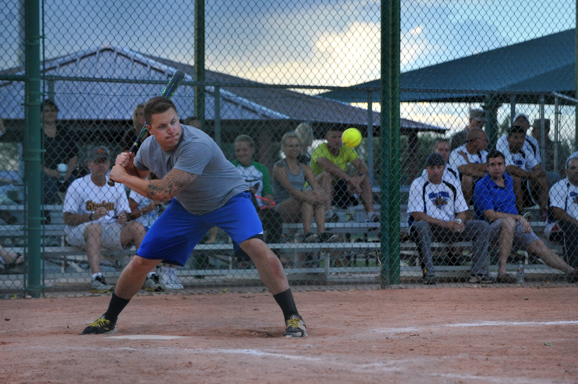 Ryan Mullan, 460th Space Wing Staff softball team member, stares down the ball as he prepares to send it over the fence during the championship softball game Aug. 20, 2014 at the softball fields on Buckley Air Force Base, Colo. The final score of the game was 24-9, making the wing staff team the 2014 intramural softball base champions. (U.S. Air Force photo by Airman Emily E. Amyotte/Released)