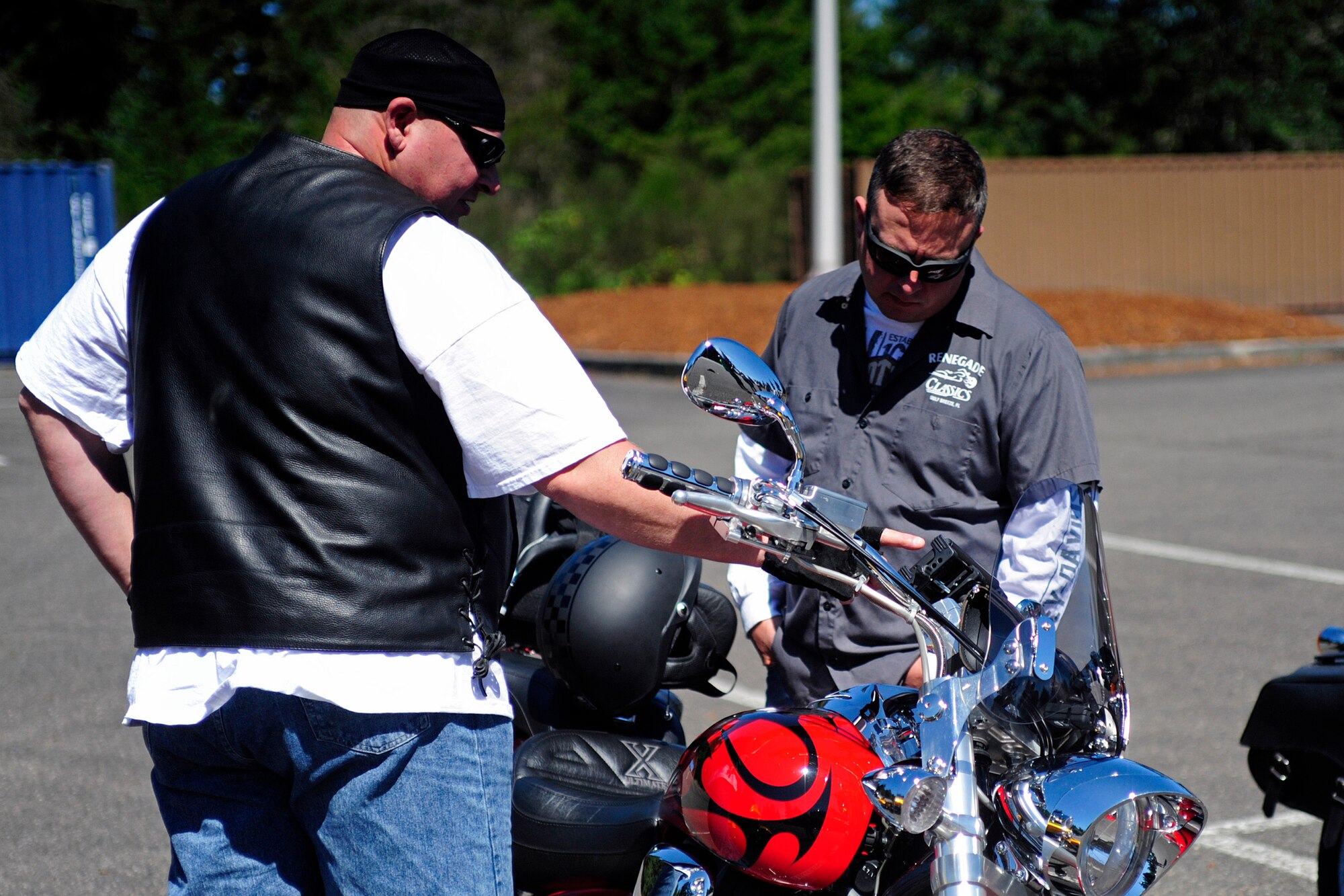 Retired Master Sgt. James Winston (left), shows Senior Master Sgt. Muarice Plummer, 62nd Maintenance Group training superintendant, his motorcycle during a motorcycle safety event Aug. 1, 2014, at Joint Base Lewis-McChord, Wash. The event was the 62nd MXG’s first group ride for safety open to all motorcyclists. (U.S. Air Force photo/Staff Sgt. Rebecca Roa-Griffith)