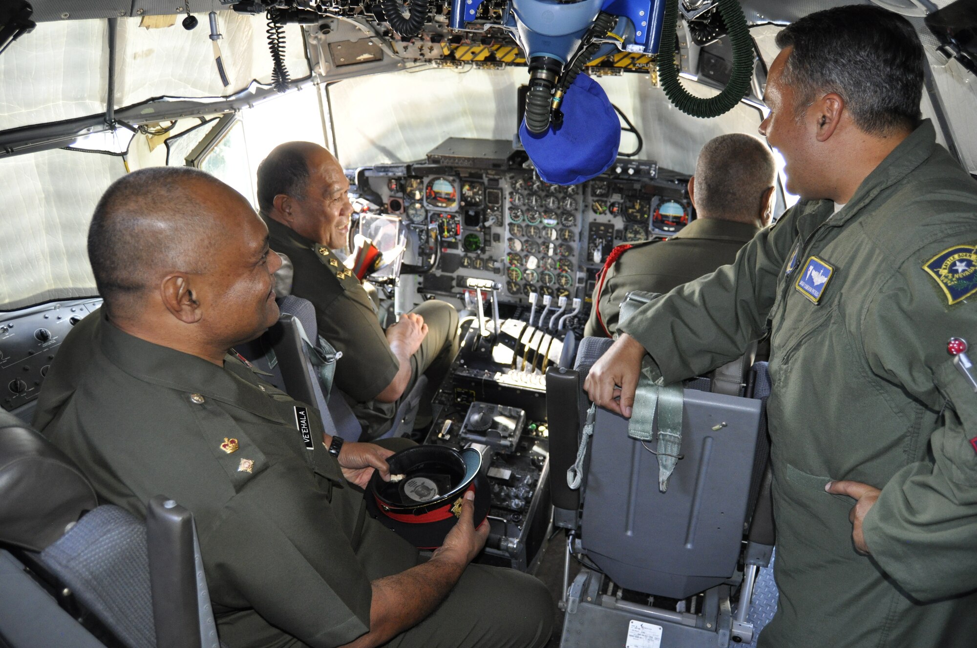 The 152nd Airlift Wing opened its doors to Brig. Gen. 'Uta'atu, Lt. Col. Lord Ve'ehala, and Senior Warrant Officer Kava of the Kingdom of Tonga’s military on August 20. Master Sgt. Cameron Pieters talks about the capabilities of the C-130 on the flight deck of the aircraft. From left to right: Lt. Col. Lord Ve'ehala, Brig. Gen. 'Uta'atu, Senior Warrant Officer Kava, and 192nd Airlift Squadron Flight Engineer, Master Sgt. Cameron Pieters. (Photo by Master Sgt. Paula Macomber, 152nd Airlift Wing Public Affairs/RELEASED)
