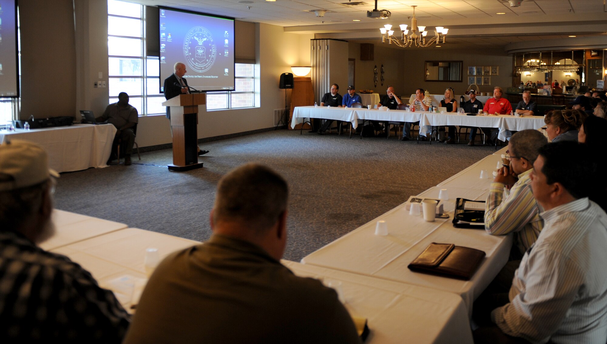 Ronald Miller, 7th Contracting Squadron director of business, briefs local small business owners Aug. 20, 2014, at Dyess Air Force Base, Texas. Miller explained the process required to apply for a government contract during a small business outreach seminar. (U.S. Air Force photo by Airman 1st Class Alexander Guerrero/Released)