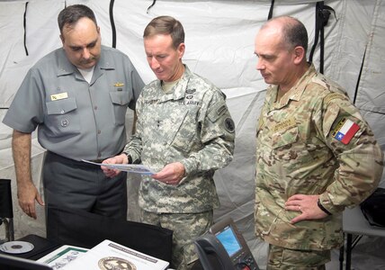 Maj. Gen. Joesph P. Disalvo (center), U.S. Army South commanding general, speaks with Chilean Rear Adm. David Hardy (right), Multinational Forces-South deputy commander of operations, and Brazilian Rear Adm. Claudio Mello, MNFS deputy commander, during a briefing at the MNFS headquarters during Fuerzas Aliadas- PANAMAX 2014 on Joint Base San Antonio-Fort Sam Houston.
Photo by Kaye Richey 