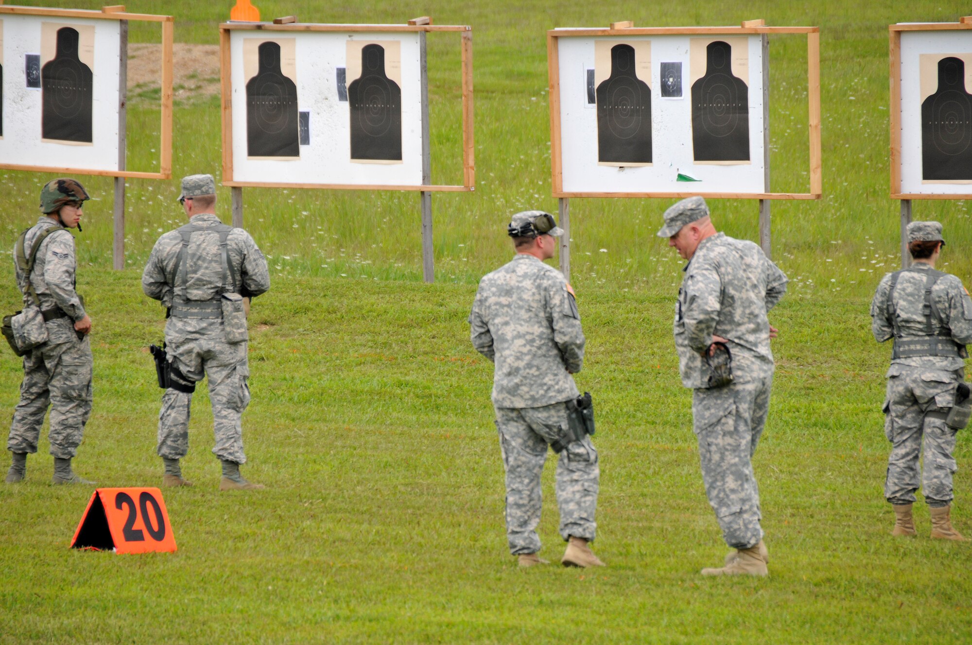 Maj. Gen. Max Haston, Tennessee Adjutant General, walks the range with Capt Timothy Butler, Range Operations Specialist, during a training session at the 2014 Tennessee Adjutant General Marksmanship Pistol Match in Tullahoma, TN on Aug 16. The Tennesee TAG Match is held anually to promote marksmanship skills in the Army and Air National Guard.  (U.S. Air National Guard photo by Master Sgt. Kendra M. Owenby, 134 ARW Public Affairs)