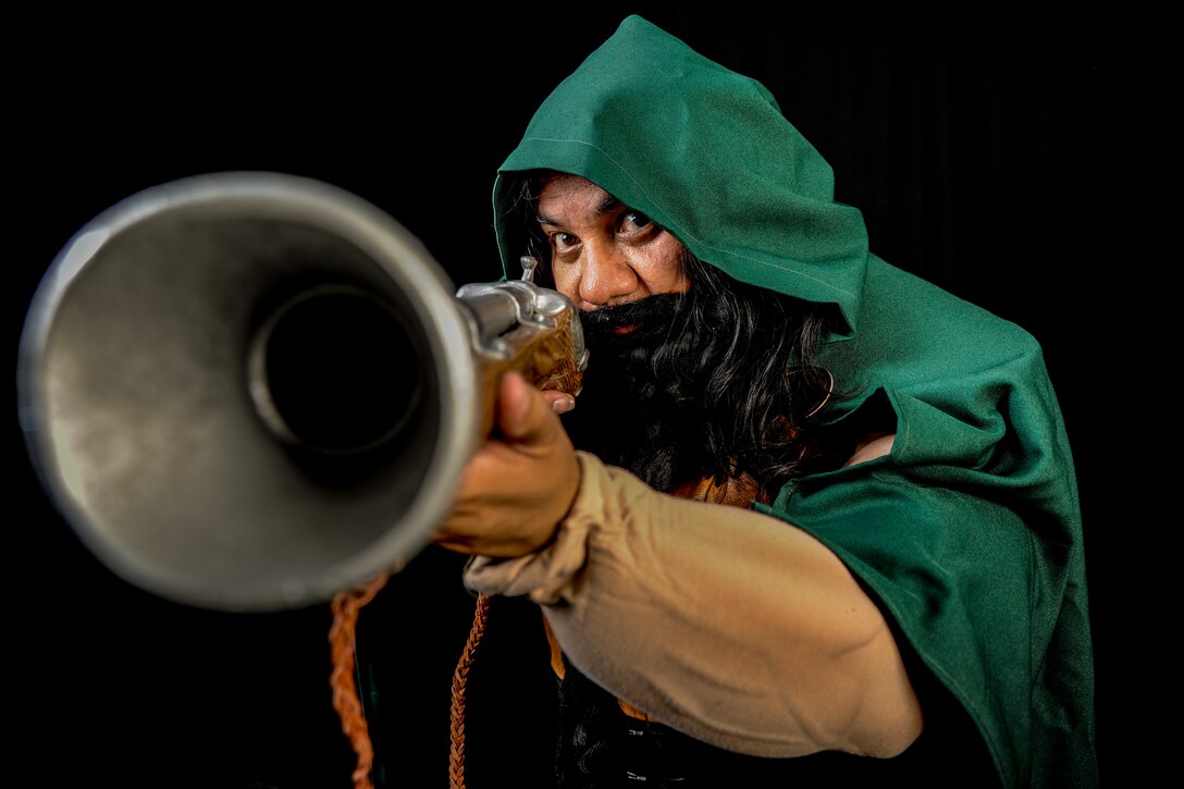 Randy Sena,11th Wing/Joint Base Andrews chief of exercises, takes aim while dressed in a Dwarf Hunter costume he created.  And avid cosplayer, Sena has won several awards for his designs. (U.S. Air Force photo/Staff Sgt. Torey Griffith)