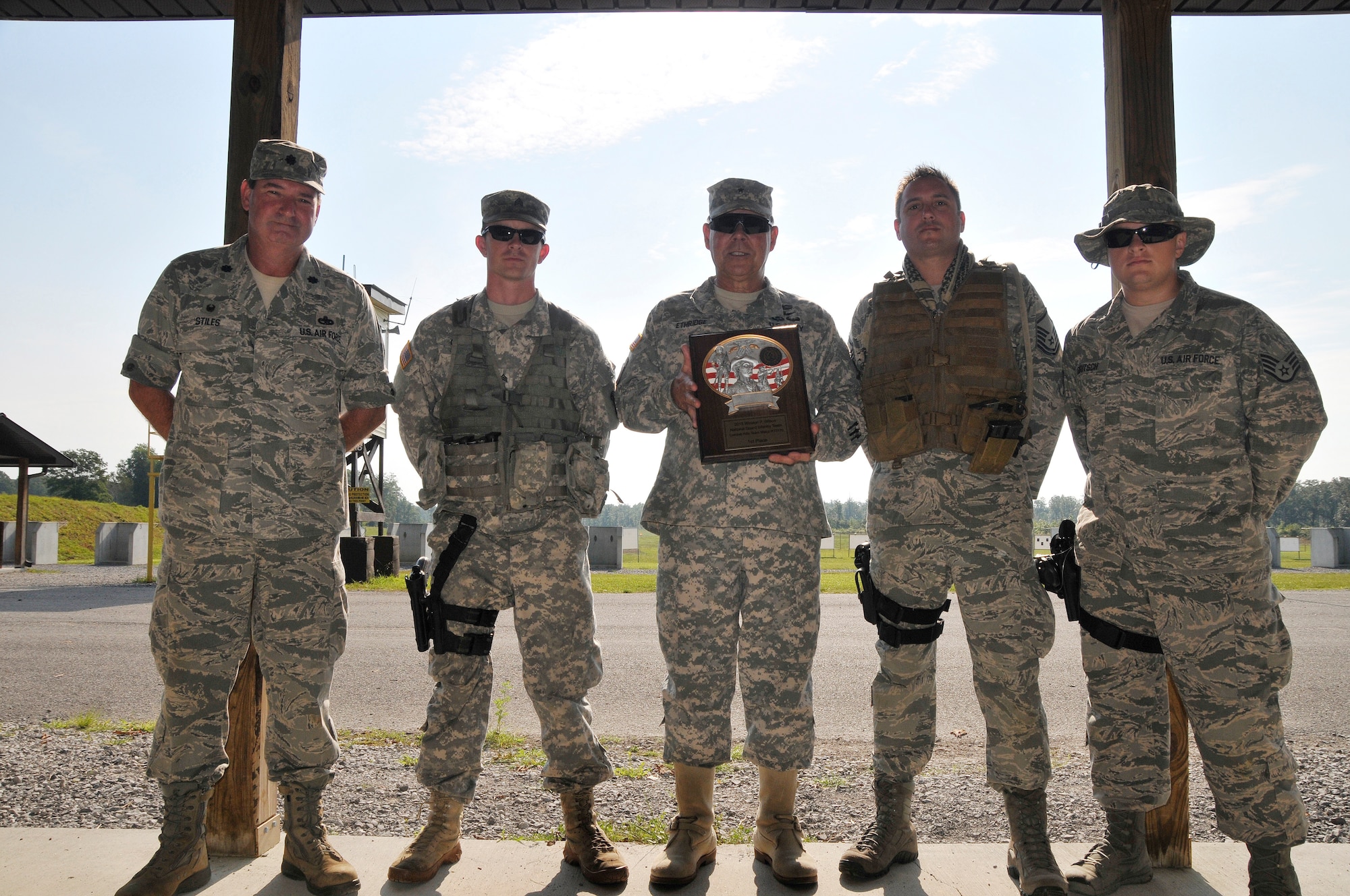 Members of the winning 2013 Combat Rifle Team present the 1st Place plaque to Brig. Gen. Terry Ethridge, Director of Staff, Tennessee National Guard during the 2014 Tennessee Adjutant General Marksmanship Pistol Match in Tullahoma, TN on Aug 16 to show thier appreciation for his support of the program. The Tennesee TAG Match is held anually to promote marksmanship skills in the Army and Air National Guard. From left to right, Lt. Col. Keith Stiles, Sgt. Casey Clark, Brig. Gen. Terry Ethridge, Master Sgt. Mike Brumer, and Staff Sgt. Ethan Deutsch.  (U.S. Air National Guard photo by Master Sgt. Kendra M. Owenby, 134 ARW Public Affairs)
