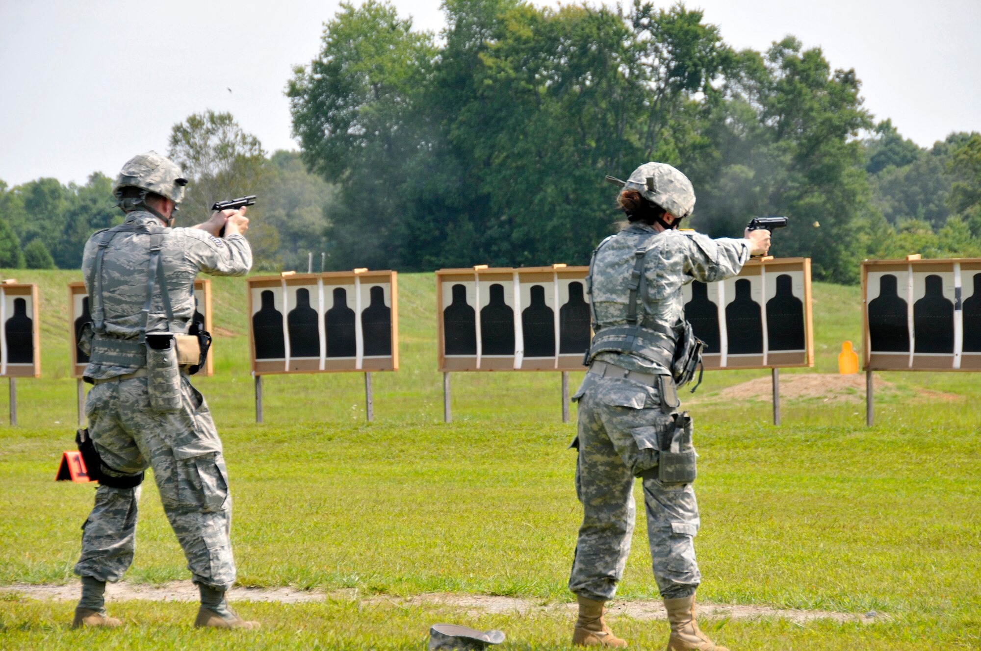 Members of the Tennessee Army and Air National Guard hone their shooting skills with a Beretta M9 service pistol during a training session at the 2014 Tennessee Adjutant General Marksmanship Pistol Match in Tullahoma, TN on Aug 16. The Tennesee TAG Match is held anually to promote marksmanship skills in the Army and Air National Guard.  (U.S. Air National Guard photo by Master Sgt. Kendra M. Owenby, 134 ARW Public Affairs)