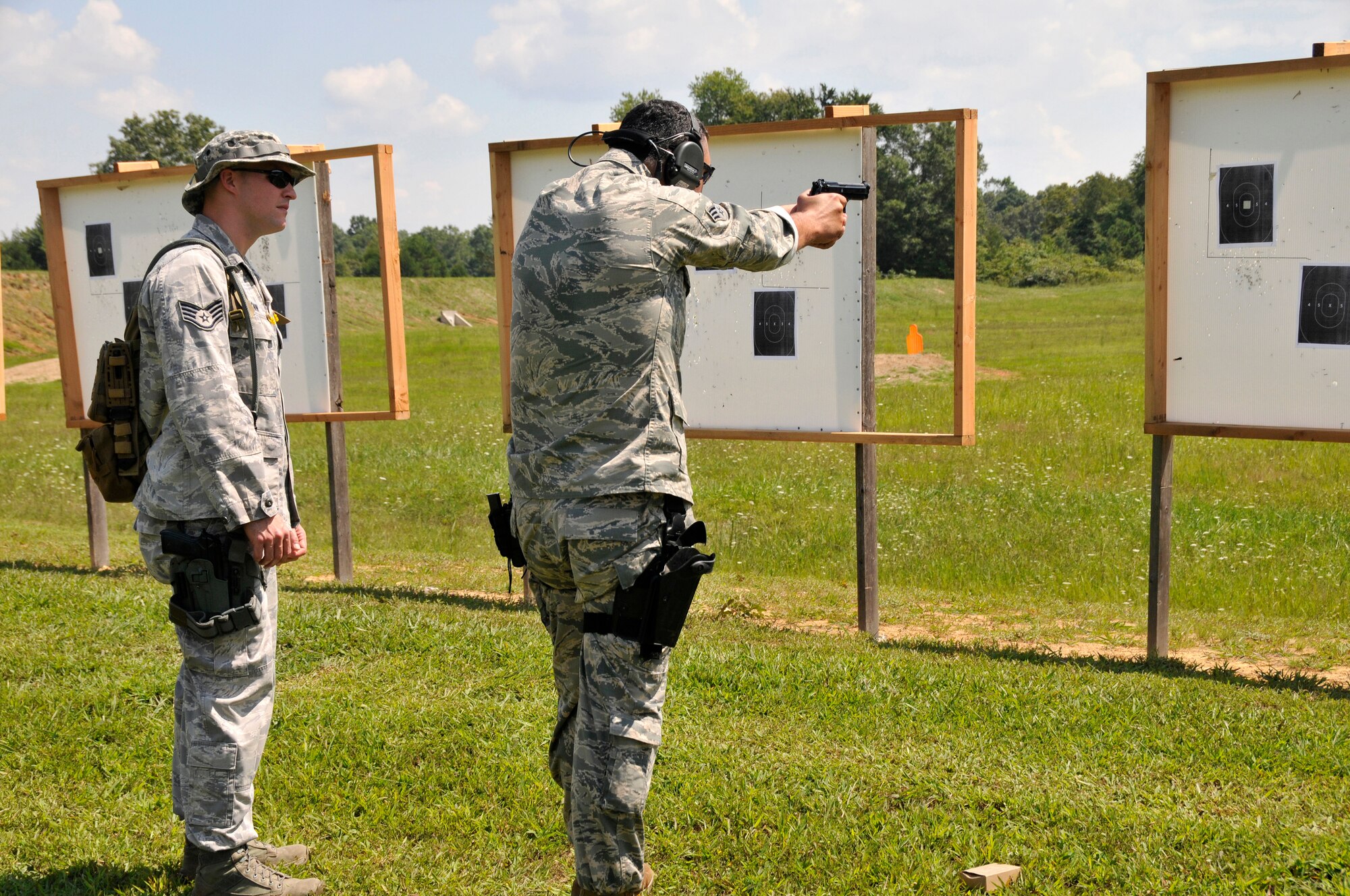 Staff Sgt. Scott Cavin (left), 134 ARW Security Forces Squadron Journeyman, serves as a range line safety for a fellow Airman at the 2014 Tennessee Adjutant General Marksmanship Pistol Match in Tullahoma, TN on Aug 15. The Tennesee TAG Match is held anually to promote marksmanship skills in the Army and Air National Guard. (U.S. Air National Guard photo by Master Sgt. Kendra M. Owenby, 134 ARW Public Affairs)