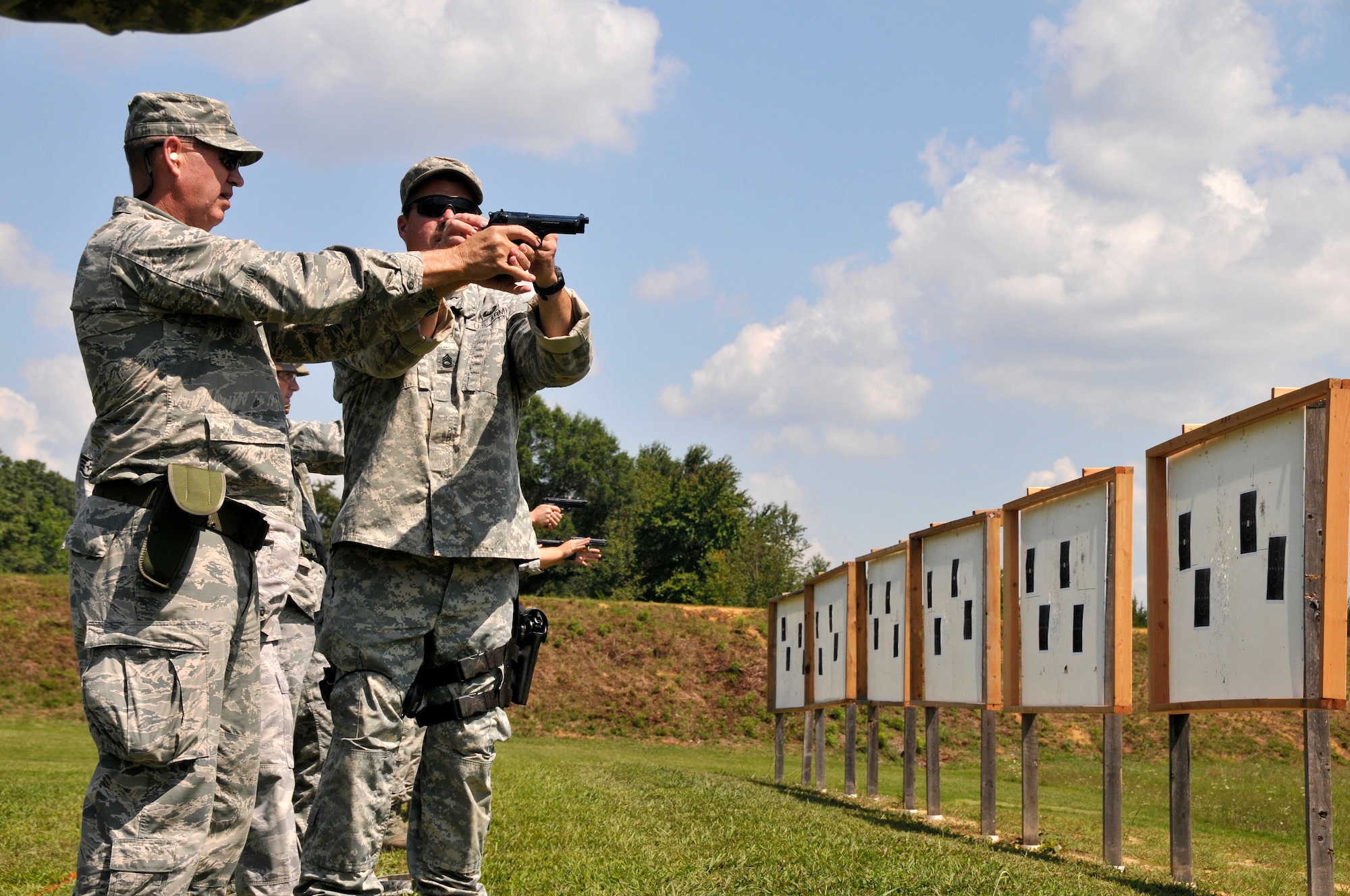 Brig. Gen. Donald Johnson, Tennessee Assistant Adjutant General, Air, is instructed on target acquisition  by Sergeant First Class Dave Keenom, TAG Match instructor and award winning pistol Champion, during a training session at the 2014 Tennessee Adjutant General Marksmanship Pistol Match in Tullahoma, TN on Aug 15. The Tennesee TAG Match is held anually to promote marksmanship skills in the Army and Air National Guard.  (U.S. Air National Guard photo by Master Sgt. Kendra M. Owenby, 134 ARW Public Affairs)