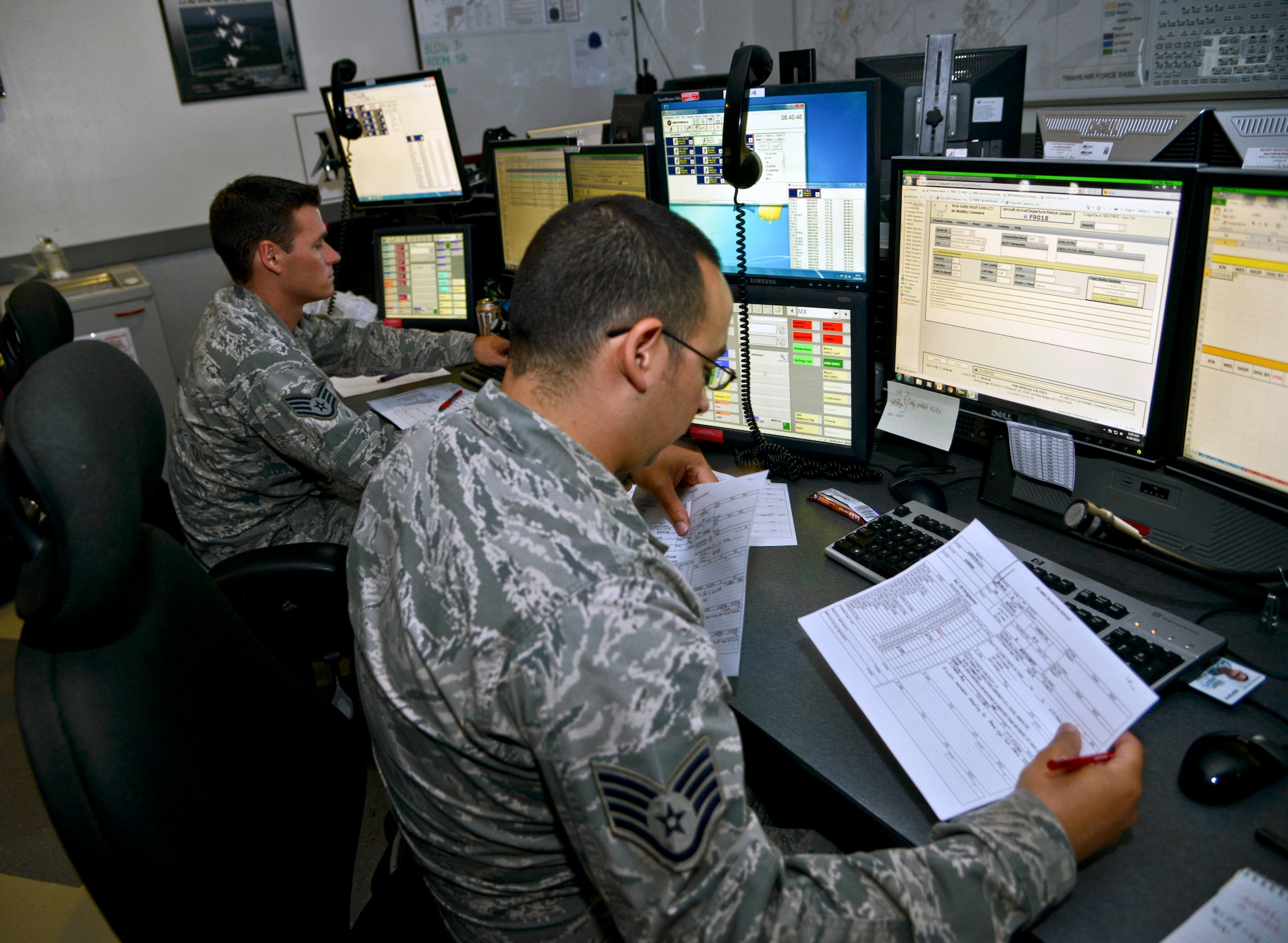 Staff Sgt. Joshua Cintron Ruiz, 60th Maintenance Operations Center KC-10 controller, ensures Wednesday that all departing and arriving KC-10 Extenders at Travis Air Force Base are on time, have the proper support agencies as needed and have the correct flight status annotated. (U.S. Air Force photo by Senior Airman Madelyn Brown)