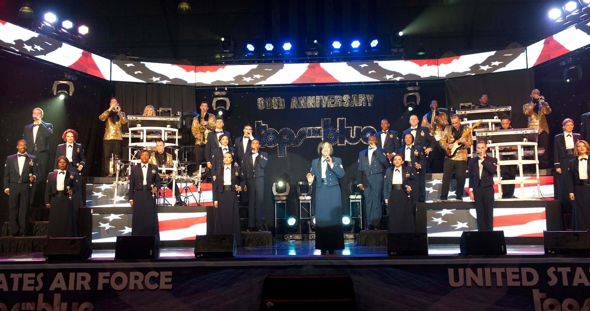 The entire U.S. Air Force Tops in Blue team sing during a performance Aug. 19, 2014, at the Wings Over the Rockies Air and Space Museum in Denver. Tops in Blue is the Air Force’s premier entertainment showcase that tours around the world, performing in 20 countries and more than 70 locations in the United States each year. (U.S. Air Force photo by Airman 1st Class Samantha Saulsbury/Released)
