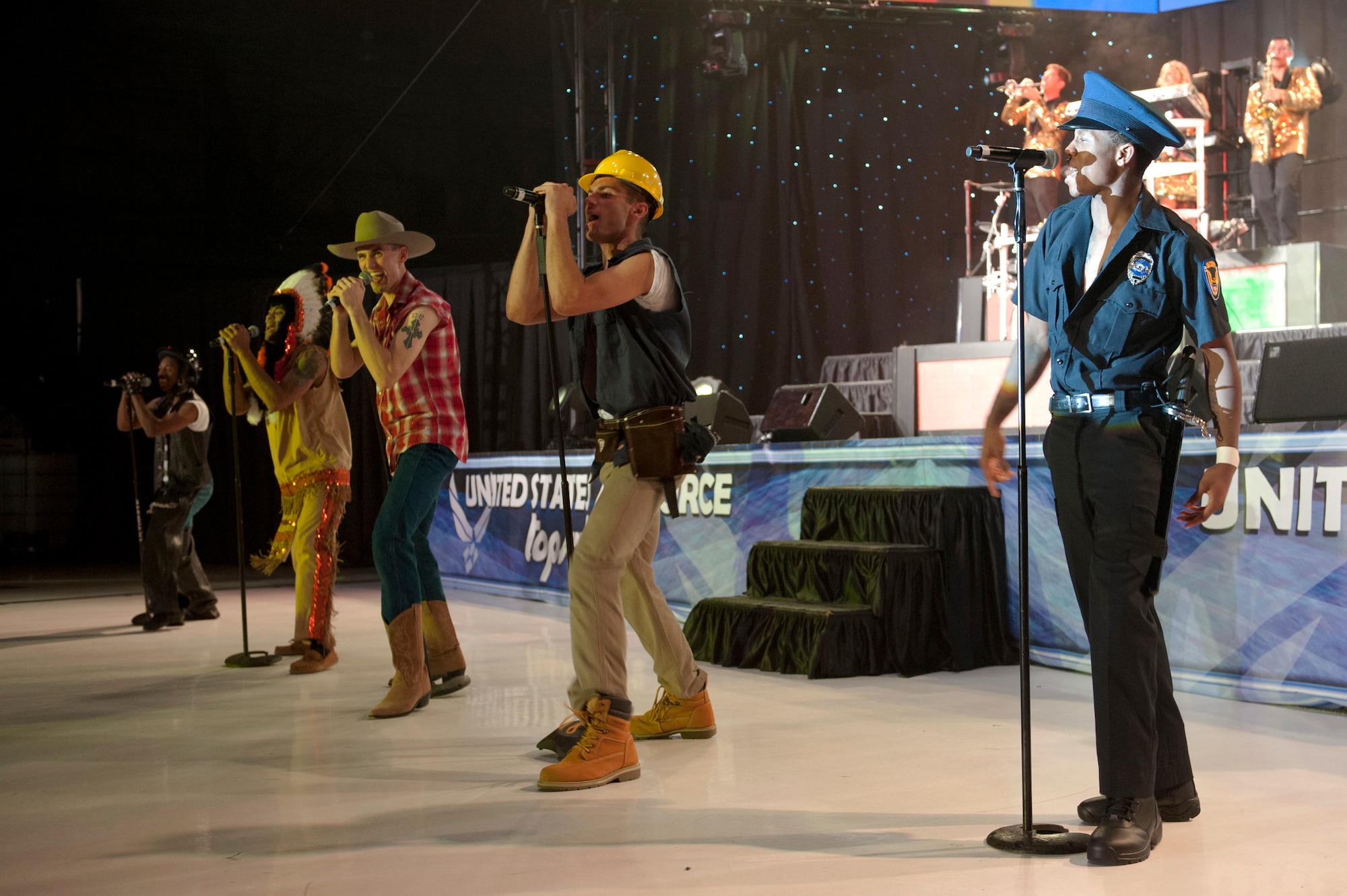 U.S. Air Force Tops in Blue members perform the song “YMCA” during their performance Aug. 19, 2014, at the Wings Over the Rockies Air and Space Museum in Denver. Tops in Blue is the Air Force’s premier entertainment showcase that tours around the world, performing in 20 countries and more than 70 locations in the United States each year. (U.S. Air Force photo by Airman 1st Class Samantha Saulsbury/Released)