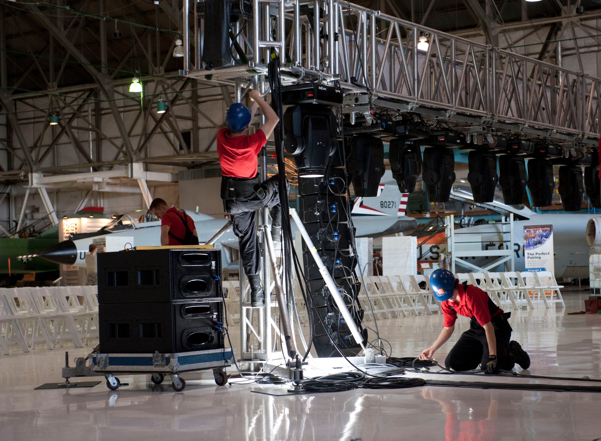 U.S. Air Force Tops in Blue members set up the stage prior to their performance Aug. 19, 2014, at the Wings Over the Rockies Air and Space Museum in Denver. Tops in Blue is the Air Force’s premier entertainment showcase that tours around the world, performing in 20 countries and more than 70 locations in the United States each year. (U.S. Air Force photo by Airman 1st Class Samantha Saulsbury/Released)