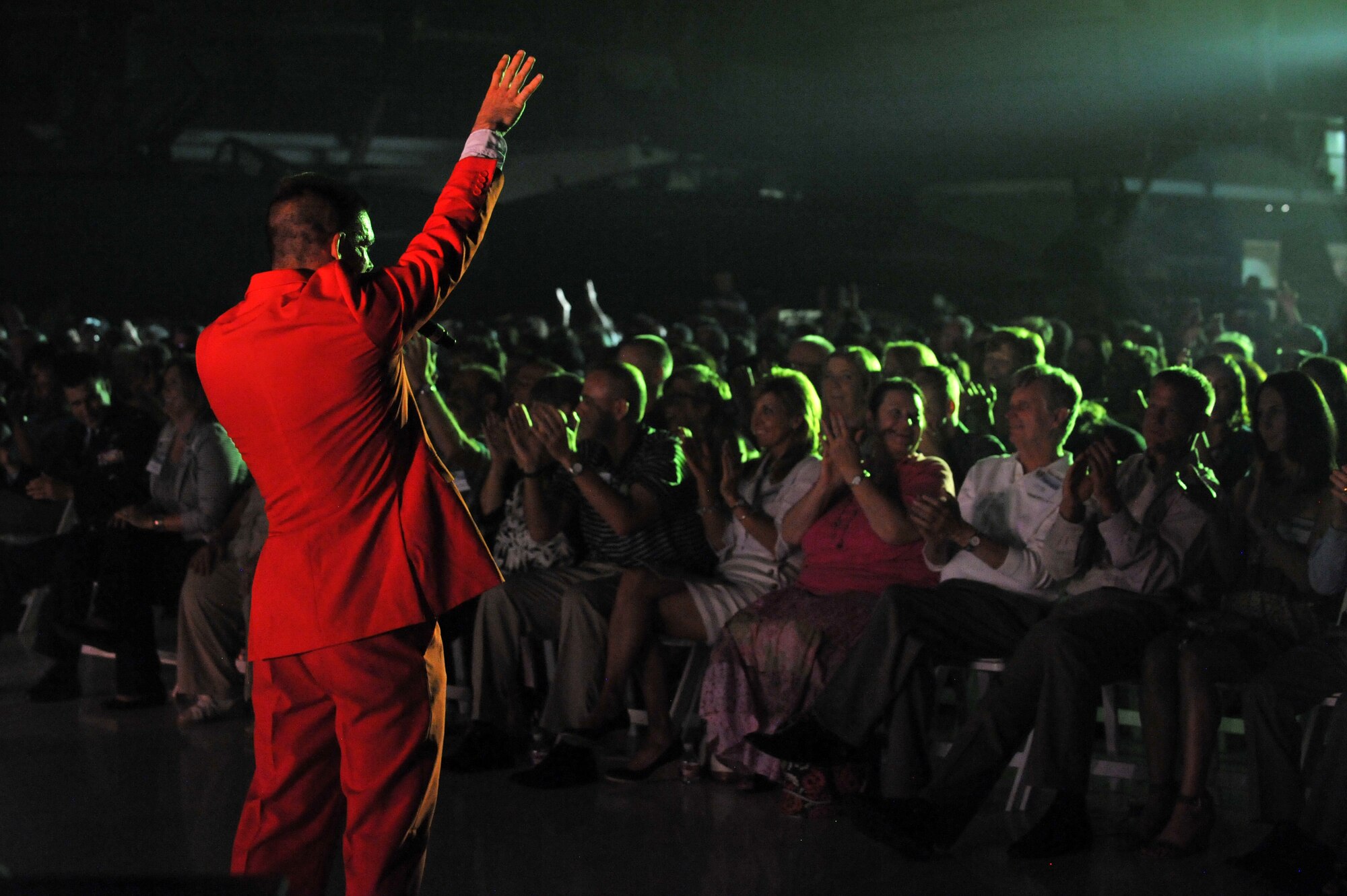 A U.S. Air Force’s Tops in Blue member sings to the crowd during a performance Aug. 19, 2014, at the Wings Over the Rockies Air and Space Museum in Denver.  Tops in Blue is the Air Force’s premier entertainment showcase that tours around the world, performing in 20 countries and more than 70 locations in the United States each year. (U.S. Air Force photo by Airman Emily E. Amyotte/Released)