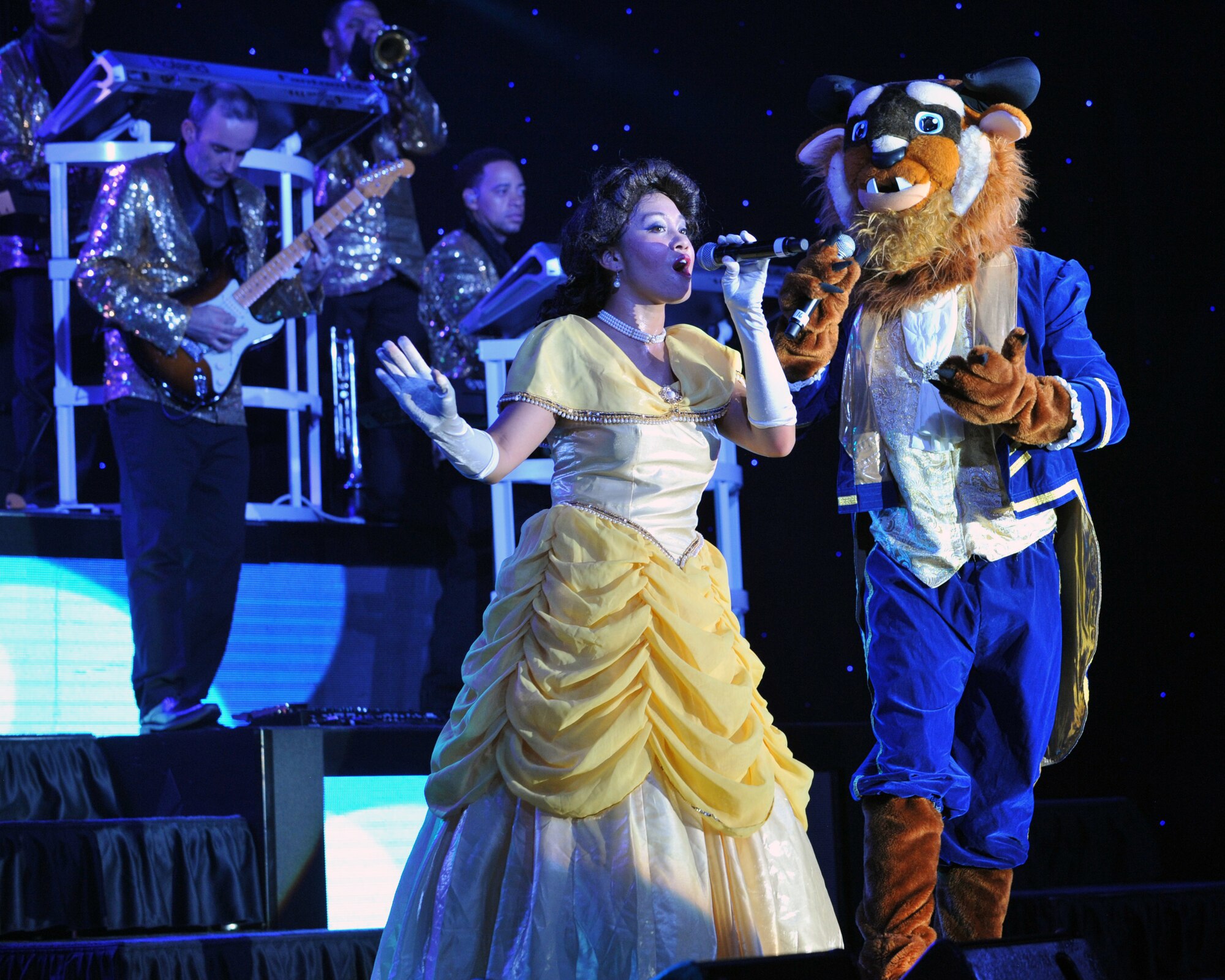 U.S. Air Force Tops in Blue members perform a rendition of  Beauty and the Beast Aug. 19, 2014, at the Wings Over the Rockies Air and Space Museum in Denver.  Tops in Blue is the Air Force’s premier entertainment showcase that tours around the world, performing in 20 countries and more than 70 locations in the United States each year. (U.S. Air Force photo by Airman Emily E. Amyotte/Released)