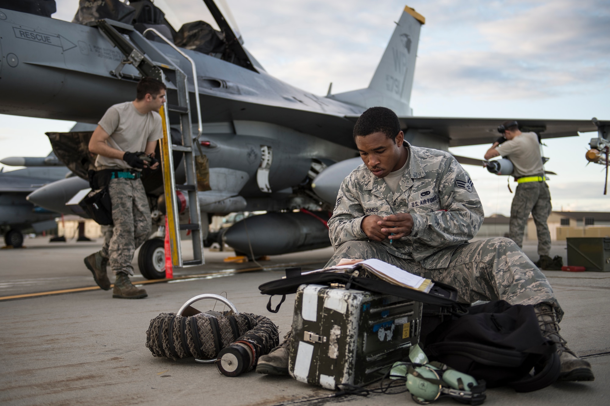 U.S. Air Force Senior Airman Ezra Jones, 80th Aircraft Maintenance Squadron aviation systems specialist assigned to Kunsan Air Base, South Korea,checks flight forms during RED FLAG-Alaska 14-3 Aug. 19, 2014, Eielson Air Force Base, Alaska. RF-A is a two week-long exercise that gives participants the opportunity to train in large-scale combat simulations involving aircraft from allied and coalition forces from around the world. (U.S. Air Force photo by Senior Airman Peter Reft/Released)