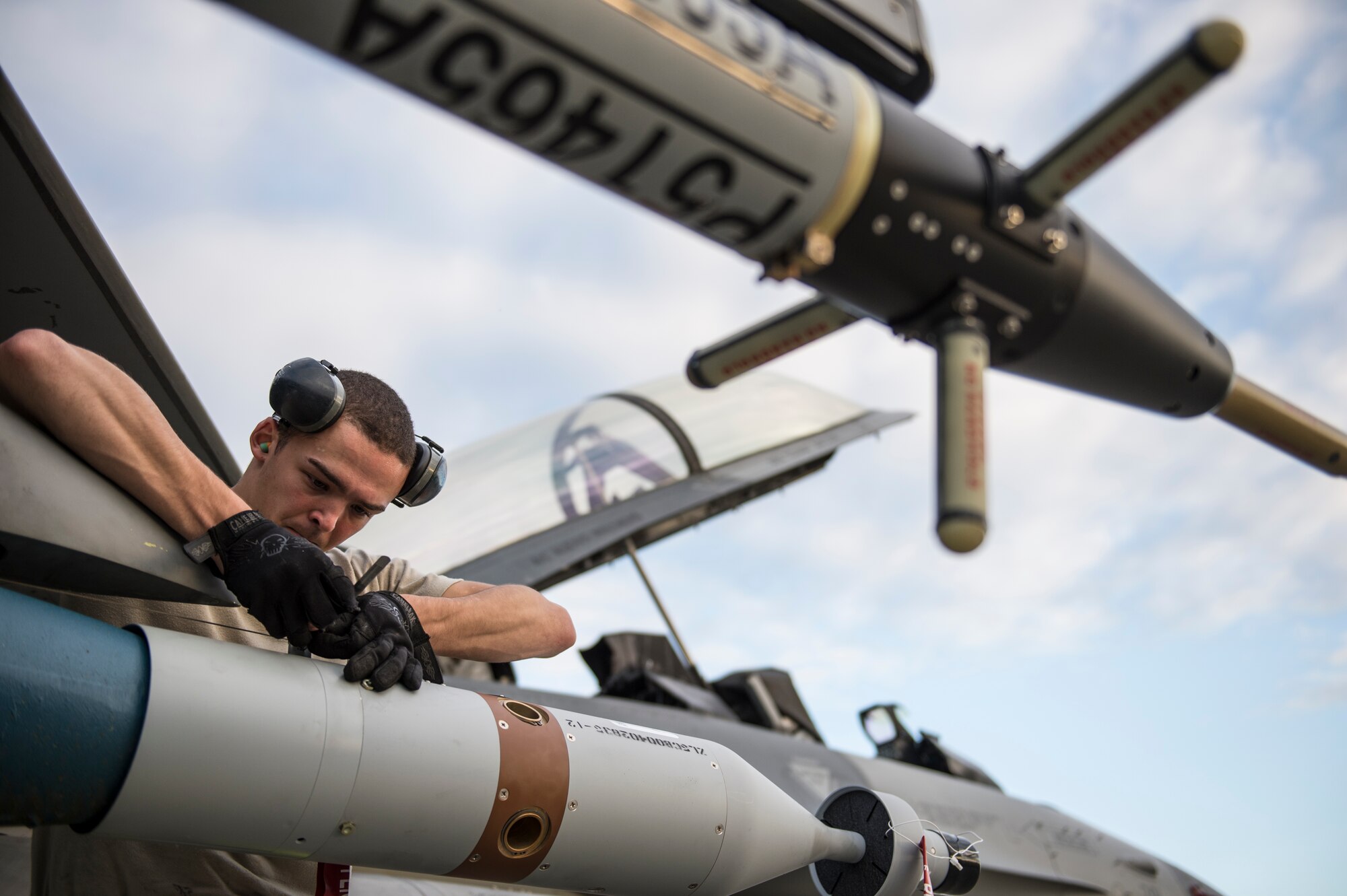 U.S. Air Force Senior Airman Ian Postler, 80th Aircraft Maintenance Unit weapons load crew member assigned to Kunsan Air Base, South Korea, secures a computer control group to a GBU-12 bomb during RED FLAG-Alaska 14-3 Aug. 19, 2014, Eielson Air Force Base, Alaska. The GBU-12 features laser guidance systems that help steer the bomb to its target during freefall. (U.S. Air Force photo by Senior Airman Peter Reft/Released)