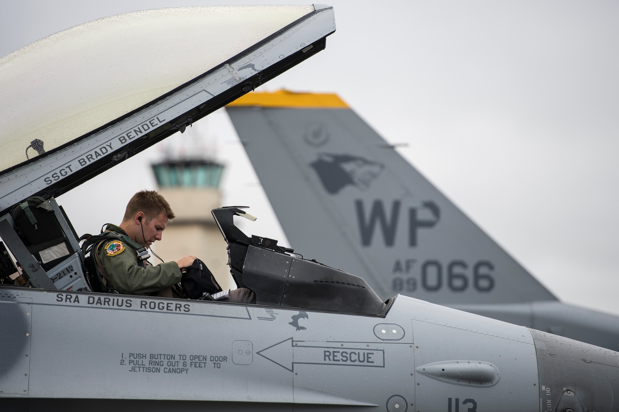 U.S. Air Force Capt. Daniel Duncan, 80th Fighter Squadron F-16 Fighting Falcon pilot assigned to Kunsan Air Base, South Korea, checks his helmet before a sortie during RED FLAG-Alaska 14-3 Aug. 19, 2014, Eielson Air Force Base, Alaska. RF-A  allowed Duncan and other 80th FS pilots to train with U.S. Marine Corps and U.S. Navy aircraft in large-scale combat simulations. (U.S. Air Force photo by Senior Airman Peter Reft/Released)