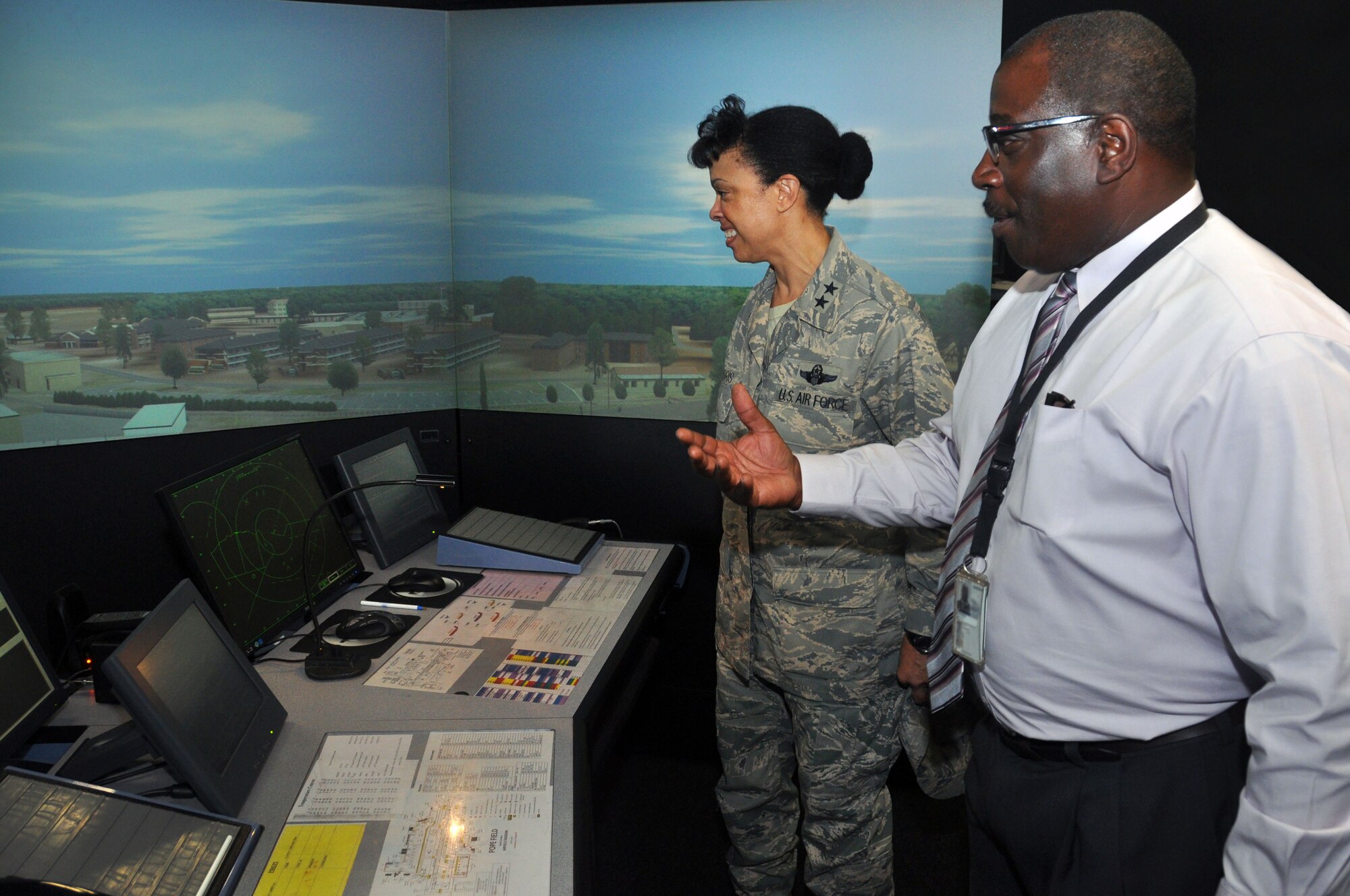 Willie Edwards, Pope Airfield operations manager, briefs 22nd Air Force Commander Maj. Gen. Stayce D. Harris during a tour of the Pope Field Tower Simulator System Aug. 19, 2014. During a three-day visit to Pope Field and Ft. Bragg Harris received a firsthand look at the 440th Airlift Wing’s mission and spoke with Airmen and leadership about the opportunities and challenges they face.  (U.S. Air Force photo by Staff Sgt. Mark Thompson) 