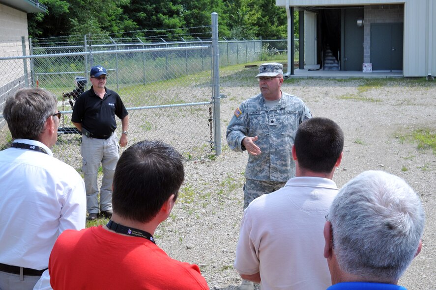 CAMP RAVENNA, Ohio – Ohio Army National Guard Lt. Col. William Meade, Camp Ravenna commander, talks with a group of attendees during the 2nd Annual Joint Employer Awareness Event outside a state-of-the-art urban combat simulation shoot house here, Aug. 8, 2014. The two-day event, designed to give civilian employers of Air Force Reservists and Ohio National Guardsmen a better understanding of the mission their employees carry out as members of the U.S. Armed Forces, also gave attendees the opportunity to get an up-close look at both the 910th's facilities at nearby Youngstown Air Reserve Station, Ohio and the Ohio National Guard's Joint Military Training Center here. U.S. Air Force photo by Tech. Sgt. James Brock