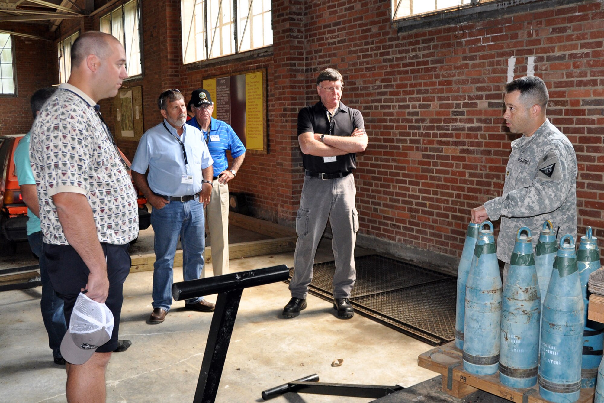 CAMP RAVENNA, Ohio – Ohio Army National Guard Maj. Richard Saphore, Camp Ravenna logisitics officer, talks with a group of attendees during the 2nd Annual Joint Employer Awareness Event in a World War II-era warehouse repurposed to house an Improvised Explosive Device (IED) recognition course here, Aug. 8, 2014. The two-day event, designed to give civilian employers of Air Force Reservists and Ohio National Guardsmen a better understanding of the mission their employees carry out as members of the U.S. Armed Forces, also gave attendees the opportunity to get an up-close look at both the 910th's facilities at nearby Youngstown Air Reserve Station, Ohio and the Ohio National Guard's Joint Military Training Center here. U.S. Air Force photo by Master Sgt. Bob Barko Jr.