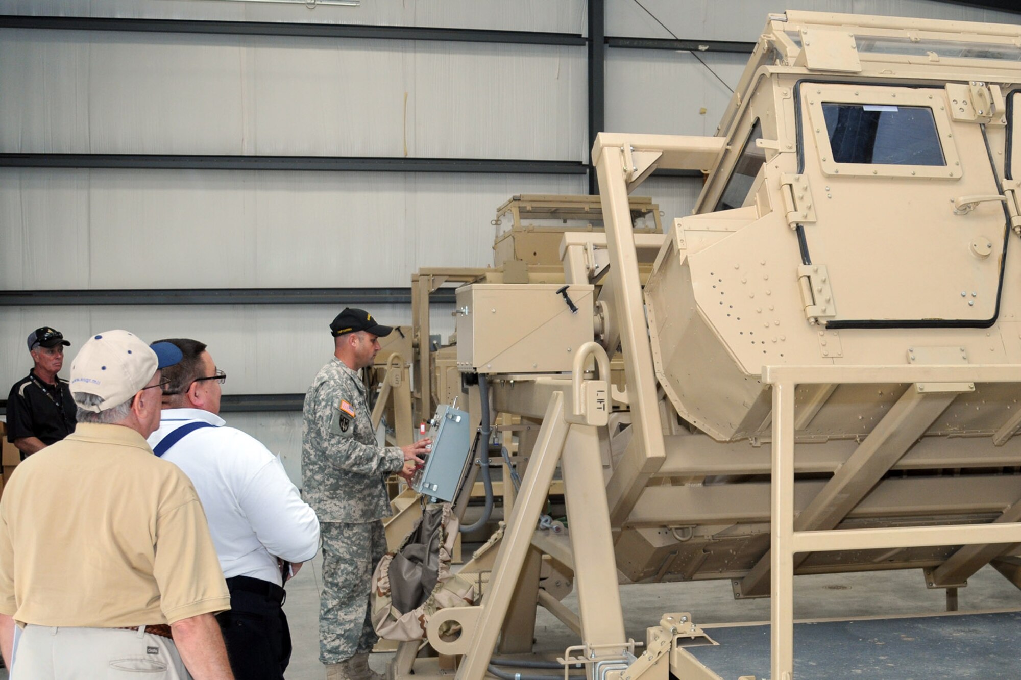CAMP RAVENNA, Ohio – Ohio Army National Guard Sgt. 1st Class Brian Fowler, a range control non-commissioned officer, explains a Humvee roll-over simulator to a group of attendees during the 2nd Annual Joint Employer Awareness Event here, Aug. 8, 2014. The two-day event, designed to give civilian employers of Air Force Reservists and Ohio National Guardsmen a better understanding of the mission their employees carry out as members of the U.S. Armed Forces, also gave attendees the opportunity to get an up-close look at both the 910th's facilities at nearby Youngstown Air Reserve Station, Ohio and the Ohio National Guard's Joint Military Training Center here. U.S. Air Force photo by Tech. Sgt. James Brock