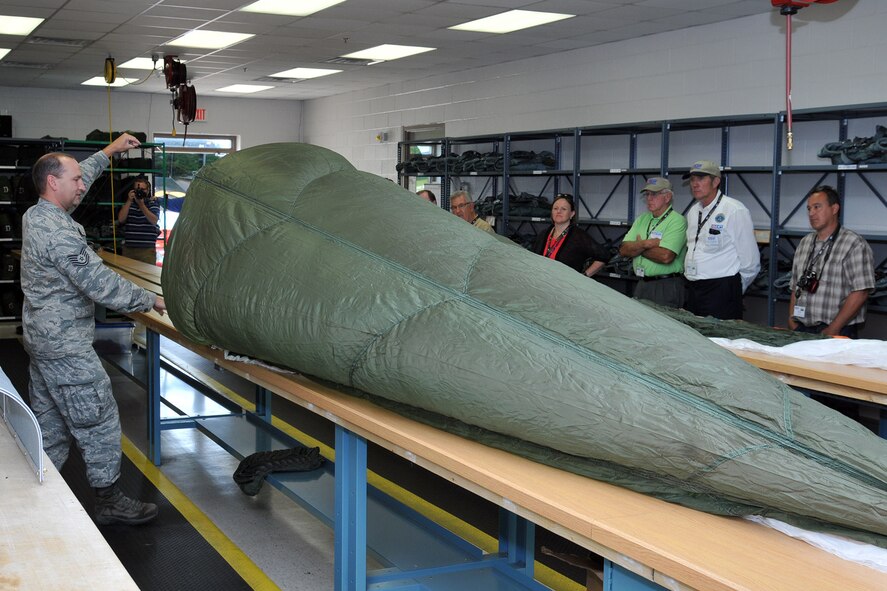 YOUNGSTOWN AIR RESERVE STATION, Ohio – Air Force Reserve Tech. Sgt. Charles Runnion, an Aircrew Flight Equipment (AFE) Craftsman assigned to the 910th Operational Support Squadron, shows a parachute to attendees of the 2nd Annual Joint Employer Awareness Event at the AFE Repair Shop here, Aug. 7, 2014. The two-day event, designed to give civilian employers of Air Force Reservists and Ohio National Guardsmen a better understanding of the mission their employees carry out as members of the U.S. Armed Forces, also gave attendees the opportunity to get an up-close look at both the 910th's facilities and the Ohio National Guard's Joint Military Training Center, located at nearby Camp Ravenna, Ohio. U.S. Air Force photo by Tech. Sgt. James Brock