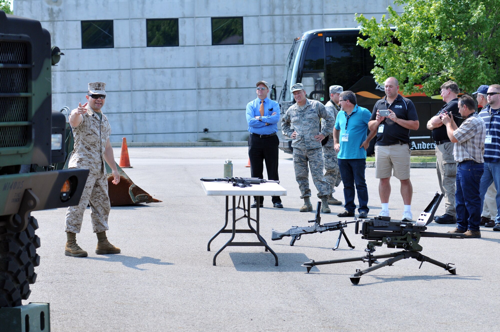 YOUNGSTOWN AIR RESERVE STATION, Ohio – Marine Corps Reserve First Sergeant Joseph Alvarez, assigned to Detachment 3, Maintenance Company, Combat Logistics Battalion 453, based here, points out an armored vehicle to a group during the 2nd Annual Joint Employer Awareness Event at a Marine Corps. equipment display at the YARS Navy and Marine Center, Aug. 7, 2014. The two-day event, designed to give civilian employers of Air Force Reservists and Ohio National Guardsmen a better understanding of the mission their employees carry out as members of the U.S. Armed Forces, also gave attendees the opportunity to get an up-close look at both the 910th's facilities and the Ohio National Guard's Joint Military Training Center, located at nearby Camp Ravenna, Ohio. U.S. Air Force photo by Tech. Sgt. James Brock