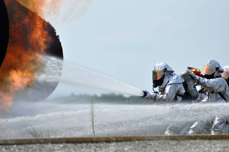 YOUNGSTOWN AIR RESERVE STATION, Ohio – Air Force Reserve firefighters, assigned to the 910th Civil Engineer Fire Department, demonstrate aircraft firefighting techniques to a group of attendees during the 2nd Annual Joint Employer Awareness Event at the fire training facility here, Aug. 7, 2014. The two-day event, designed to give civilian employers of Air Force Reservists and Ohio National Guardsmen a better understanding of the mission their employees carry out as members of the U.S. Armed Forces, also gave attendees the opportunity to get an up-close look at both the 910th's facilities and the Ohio National Guard's Joint Military Training Center, located at nearby Camp Ravenna, Ohio. U.S. Air Force photo by Master Sgt. Bob Barko Jr.