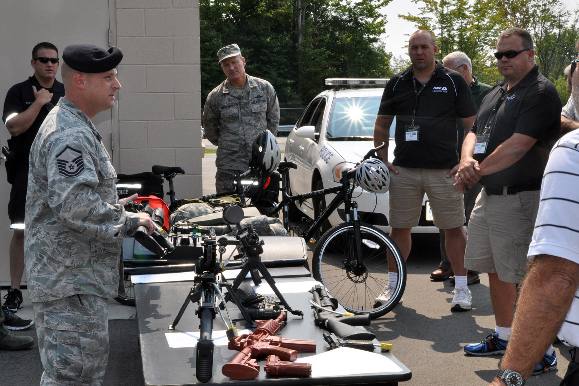 YOUNGSTOWN AIR RESERVE STATION, Ohio – Air Force Reserve Master Sgt. Brody Grazier, 910th Security Forces Squadron Unit Training Manager, shows a weapon to a group of attendees during the 2nd Annual Joint Employer Awareness Event here, Aug. 7, 2014. The two-day event, designed to give civilian employers of Air Force Reservists and Ohio National Guardsmen a better understanding of the mission their employees carry out as members of the U.S. Armed Forces, also gave attendees the opportunity to get an up-close look at both the 910th's facilities and the Ohio National Guard's Joint Military Training Center, located at nearby Camp Ravenna, Ohio. U.S. Air Force photo by Master Sgt. Bob Barko Jr.