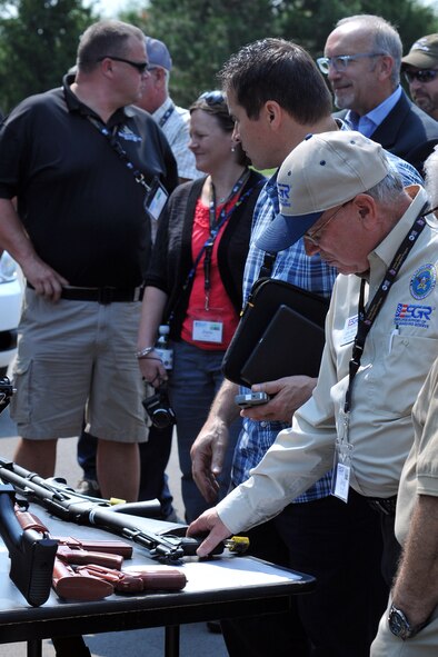 YOUNGSTOWN AIR RESERVE STATION, Ohio – Mr. John Marino, a military outreach coordinator with Ohio Employer Support of the Guard and Reserve (ESGR), picks up an M9 pistol at a 910th Security Forces Squadron equipment display during the 2nd Annual Joint Employer Awareness Event here, Aug. 7, 2014. The two-day event, designed to give civilian employers of Air Force Reservists and Ohio National Guardsmen a better understanding of the mission their employees carry out as members of the U.S. Armed Forces, also gave attendees the opportunity to get an up-close look at both the 910th's facilities and the Ohio National Guard's Joint Military Training Center, located at nearby Camp Ravenna, Ohio. U.S. Air Force photo by Tech. Sgt. James Brock