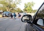 Left to right: Malachi Austin, William Thornton and Izabelle Schultz use a crosswalk Aug. 11 at Joint Base San Antonio-Randolph. (U.S. Air Force photo by Melissa Peterson)
