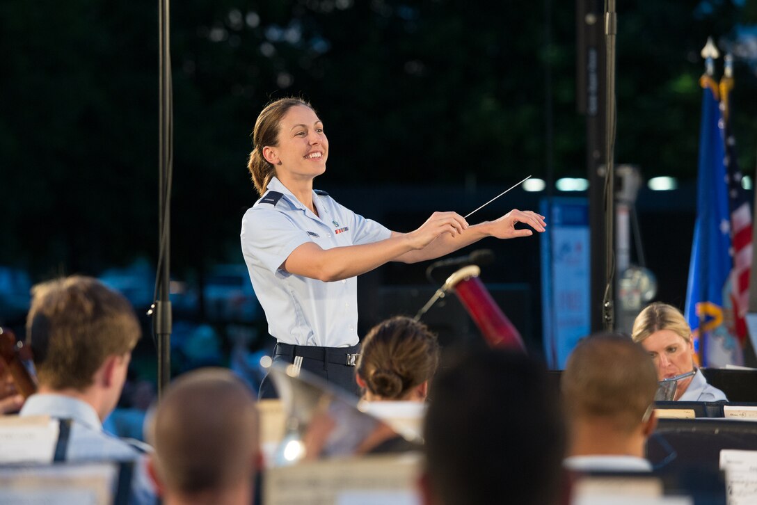Lt. Shanti Nolan conducts the USAF Band during one of their summer concerts at the Air Force Memorial on Aug. 15. This is her last set of concerts with the band before joining the USAF Academy Band in Colorado Springs. (Courtesy photo by retired Chief Master Sgt. Jan Duga)