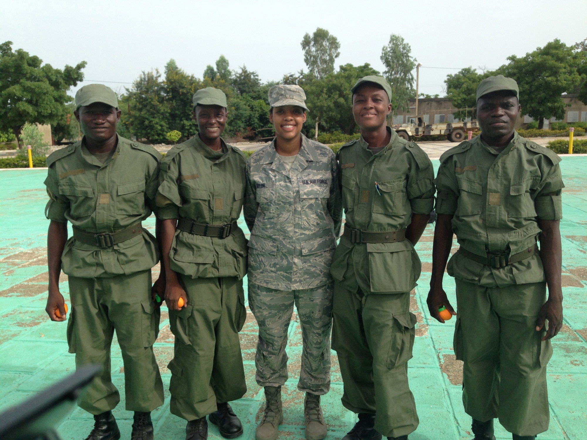 Air Force Master Sgt. Zakiya Taylor of the Kentucky Air National Guard’s 123rd Airlift Wing poses with African military cadets while serving as a cadre leader for U.S. Army Cadets participating in the U.S. Army Cadet Command’s Cultural Understanding and Language Proficiency Program in Burkina Faso in June 2014. The program strengthens cultural awareness and foreign language proficiency skills among the Army’s future leaders. (Courtesy photo)