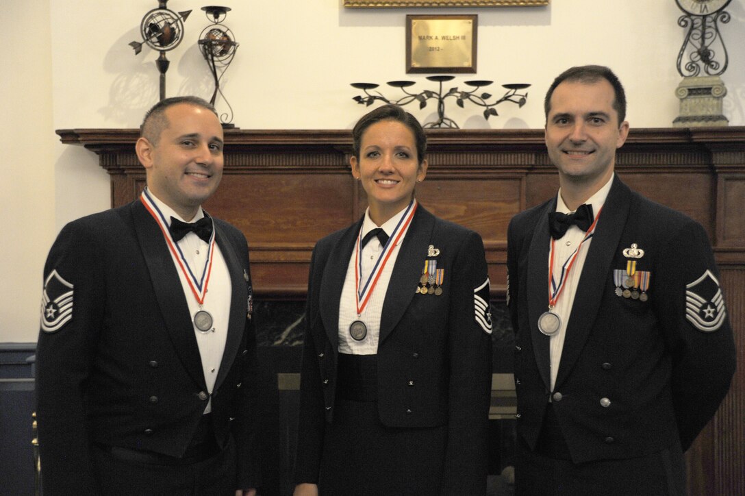 The USAF band congratulates Master Sgts. Haughton, Wellington, and Dorosheff on completing the Senior NCO Induction Ceremony, Friday August 15.  (U.S. Air Force photo/released)