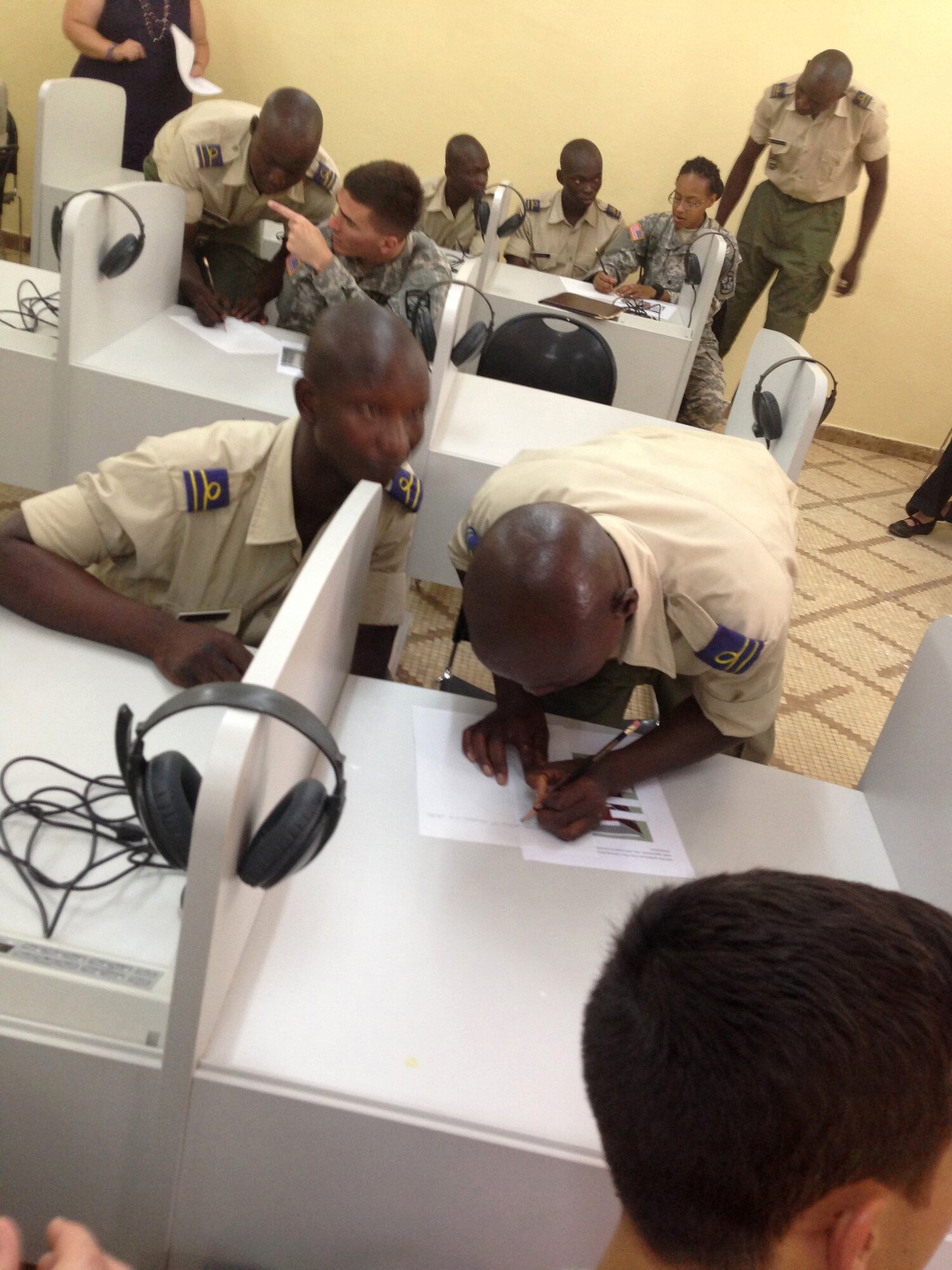 U.S. Army Cadets William Hamilton and Latia Jones assist Burkinabe officer cadets with English language skills at the Georges Namoano Military Academy in Burkina Faso in June 2014. The U.S. Army cadets were participating in the U.S. Army Cadet Command’s Cultural Understanding and Language Proficiency Program, which is designed to strengthen cultural awareness and foreign language skills among the Army’s future leaders. (Courtesy photo)