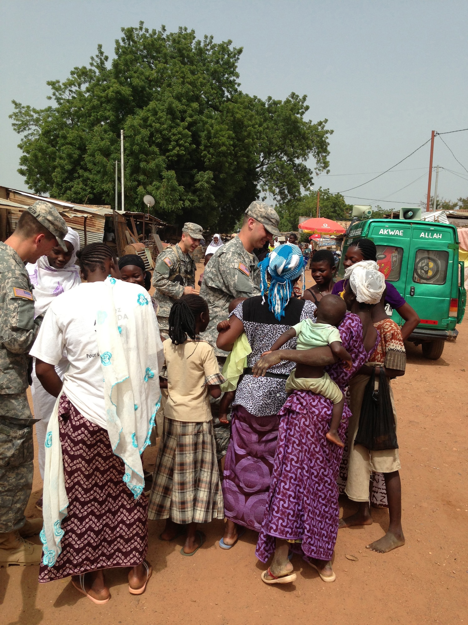 U.S. Army Cadets participating in the U.S. Army Cadet Command’s Cultural Understanding and Language Proficiency Program greet children and shop owners in the city of Po, Burkina Faso, in June 2014. The Cadets were visiting the African nation to strengthen cultural awareness and foreign language skills while training with Burkinabe officer cadets at the Georges Namoano Military Academy. (Courtesy photo)