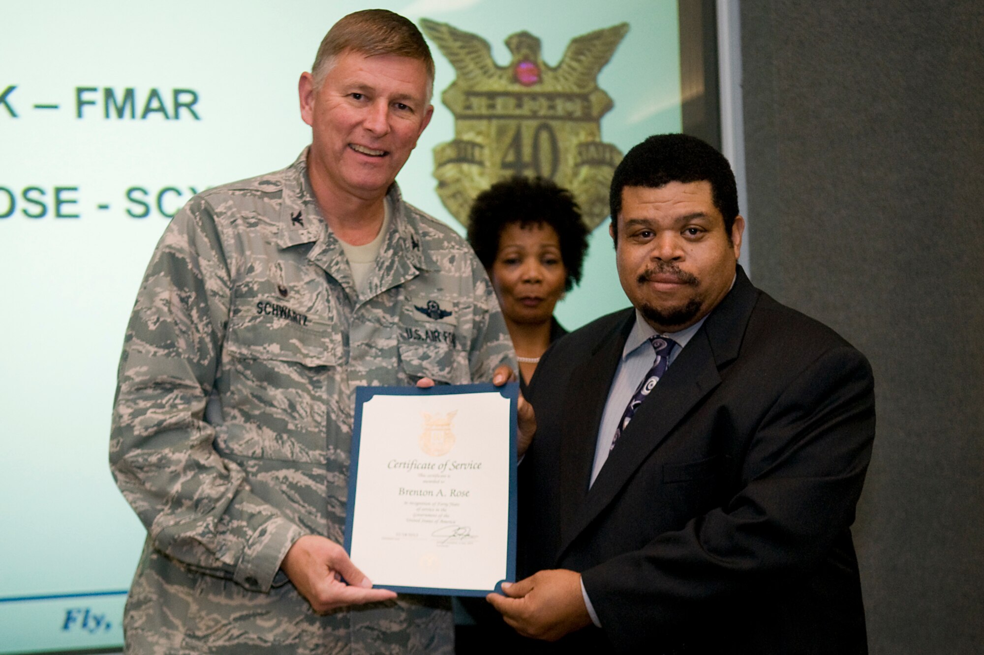 Col. Doug Schwartz, 434th Air Refueling Wing commander, presents Brenton Rose, 434th Communications Squadron, with a certificate of service for completing 40 years as a federal employee during a civilian commander's call at Grissom Air Reserve Base, Ind., Aug. 13, 2014. Civil service employees are an essential part Grissom and serve critical roles in maintaining unit readiness and daily operations. (U.S. Air Force photo/Tech. Sgt. Mark R. W. Orders-Woempner)
