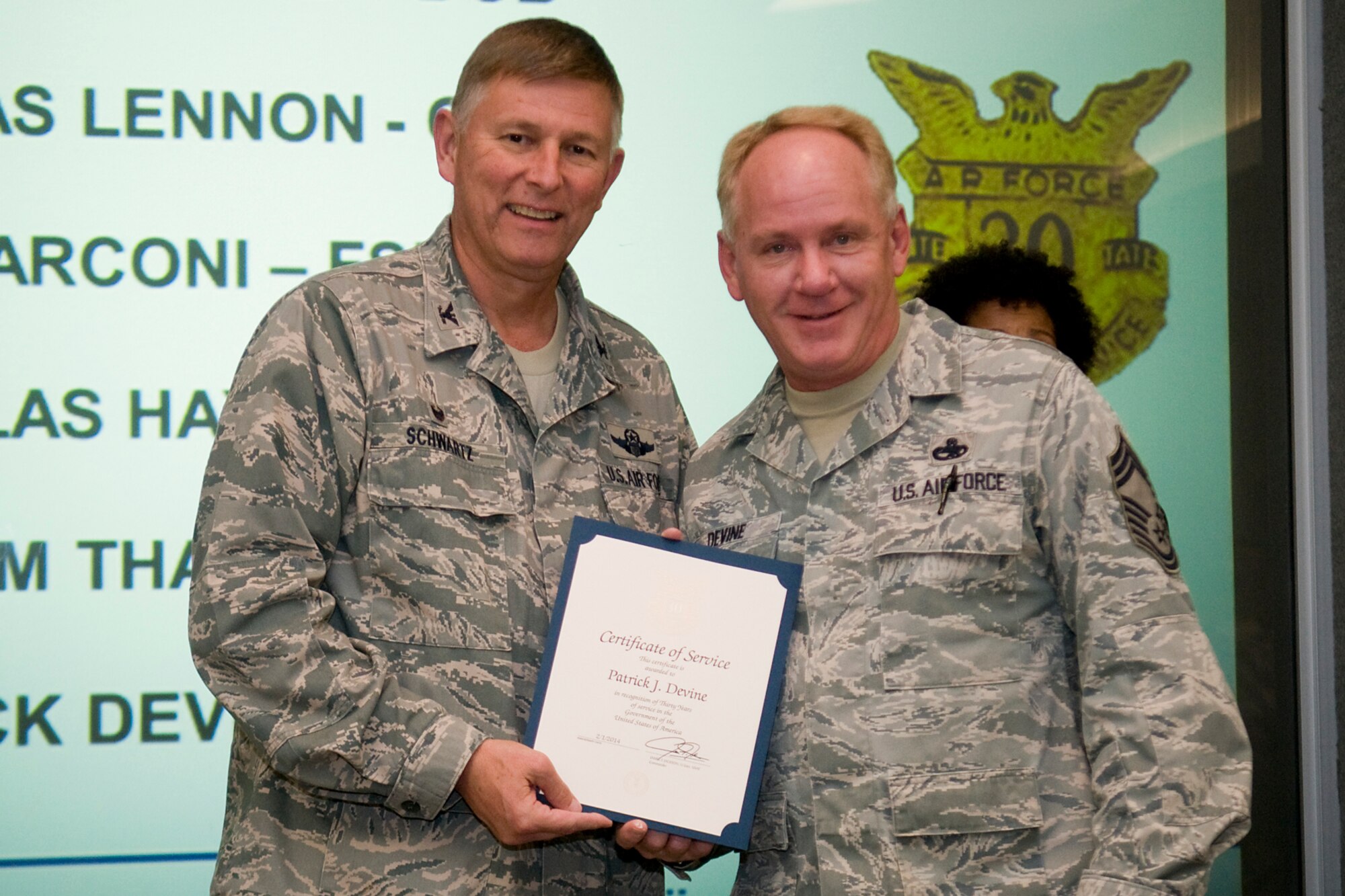 Col. Doug Schwartz, 434th Air Refueling Wing commander, presents Chief Master Sgt. Patrick Devine, 434th Aircraft Maintenance Squadron, with a certificate of service for completing 30 years as a federal employee during a civilian commander's call at Grissom Air Reserve Base, Ind., Aug. 13, 2014. Civil service employees are an essential part Grissom and serve critical roles in maintaining unit readiness and daily operations. (U.S. Air Force photo/Tech. Sgt. Mark R. W. Orders-Woempner)
