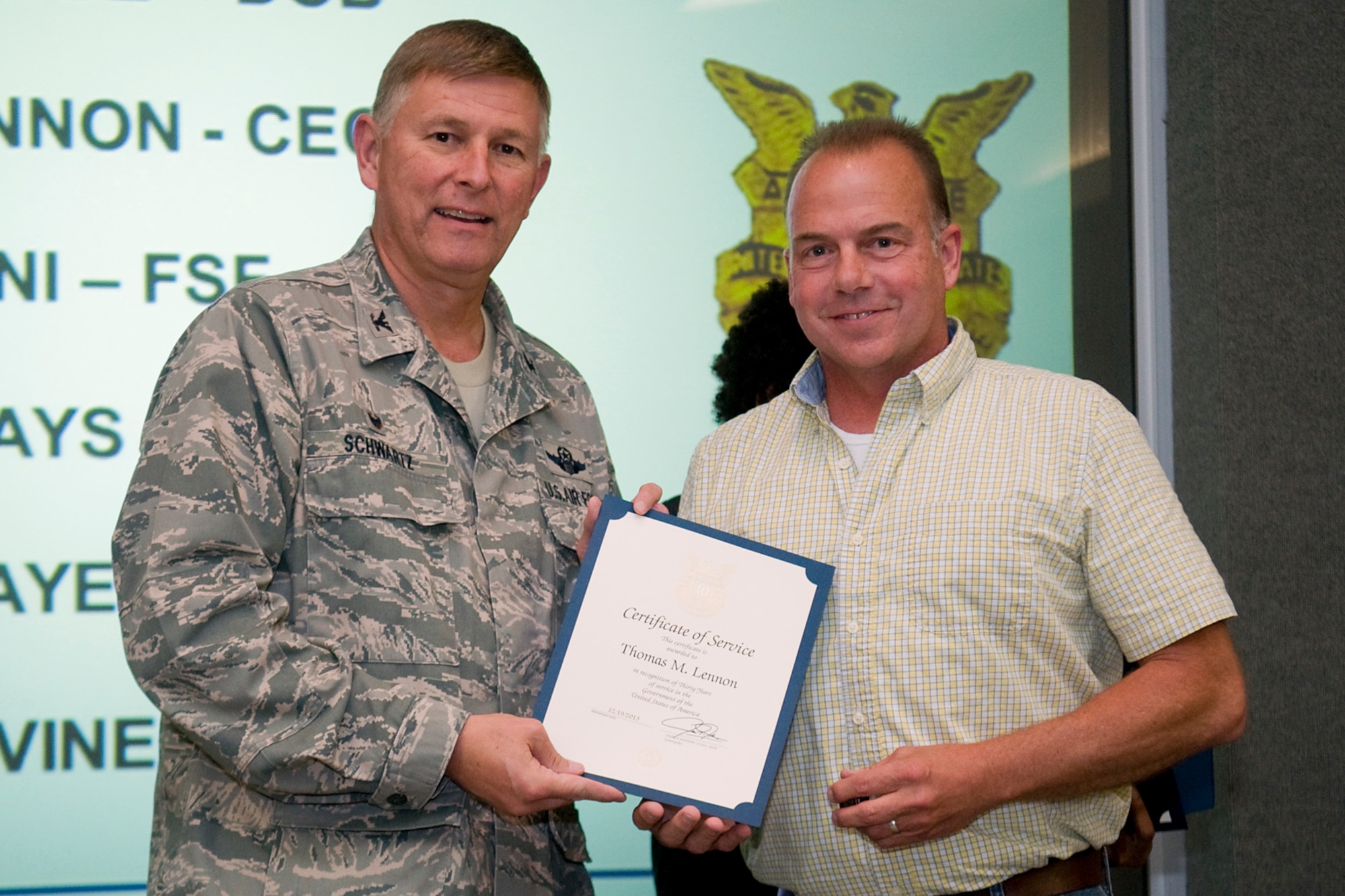 Col. Doug Schwartz, 434th Air Refueling Wing commander, presents Thomas Lennon, 434th Mission Support Group, with a certificate of service for completing 30 years as a federal employee during a civilian commander's call at Grissom Air Reserve Base, Ind., Aug. 13, 2014. Civil service employees are an essential part Grissom and serve critical roles in maintaining unit readiness and daily operations. (U.S. Air Force photo/Tech. Sgt. Mark R. W. Orders-Woempner)
